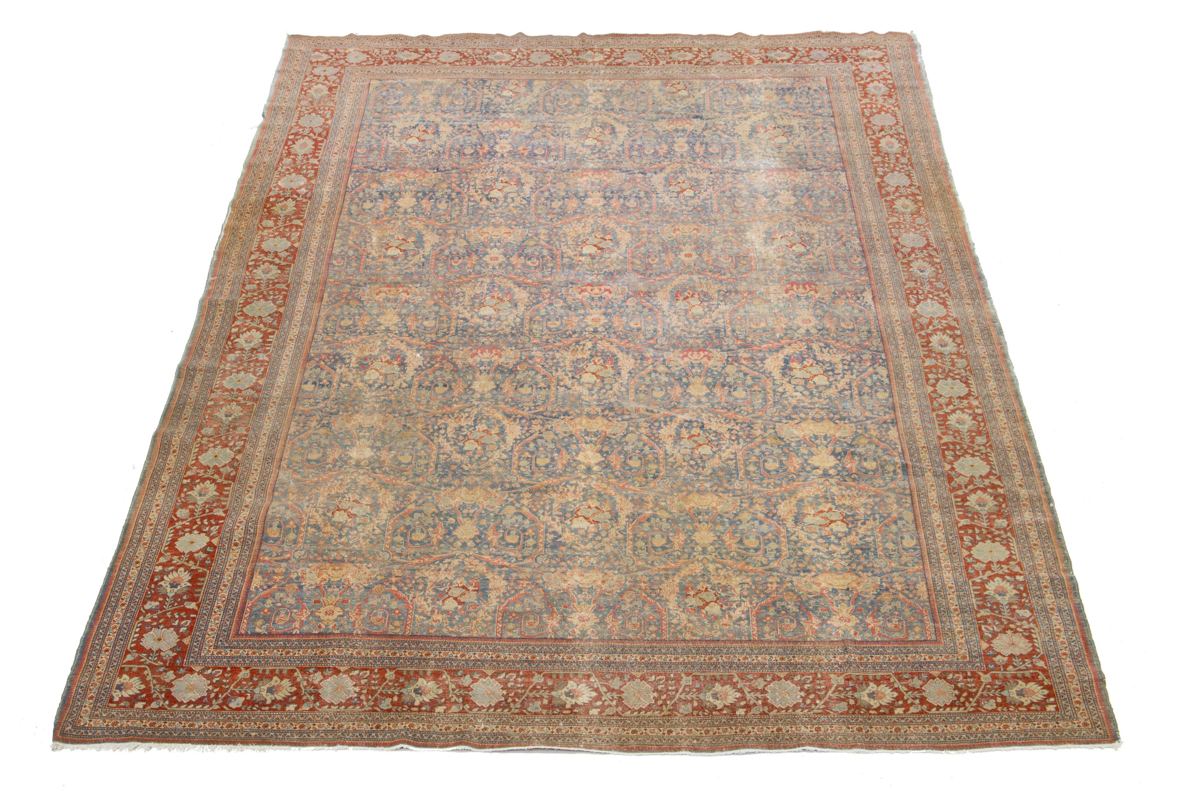 Ce tapis antique Mahal en laine nouée à la main présente un motif all-over avec des accents beiges, pêche et rouges sur un fond bleu.

Ce tapis mesure 9'11