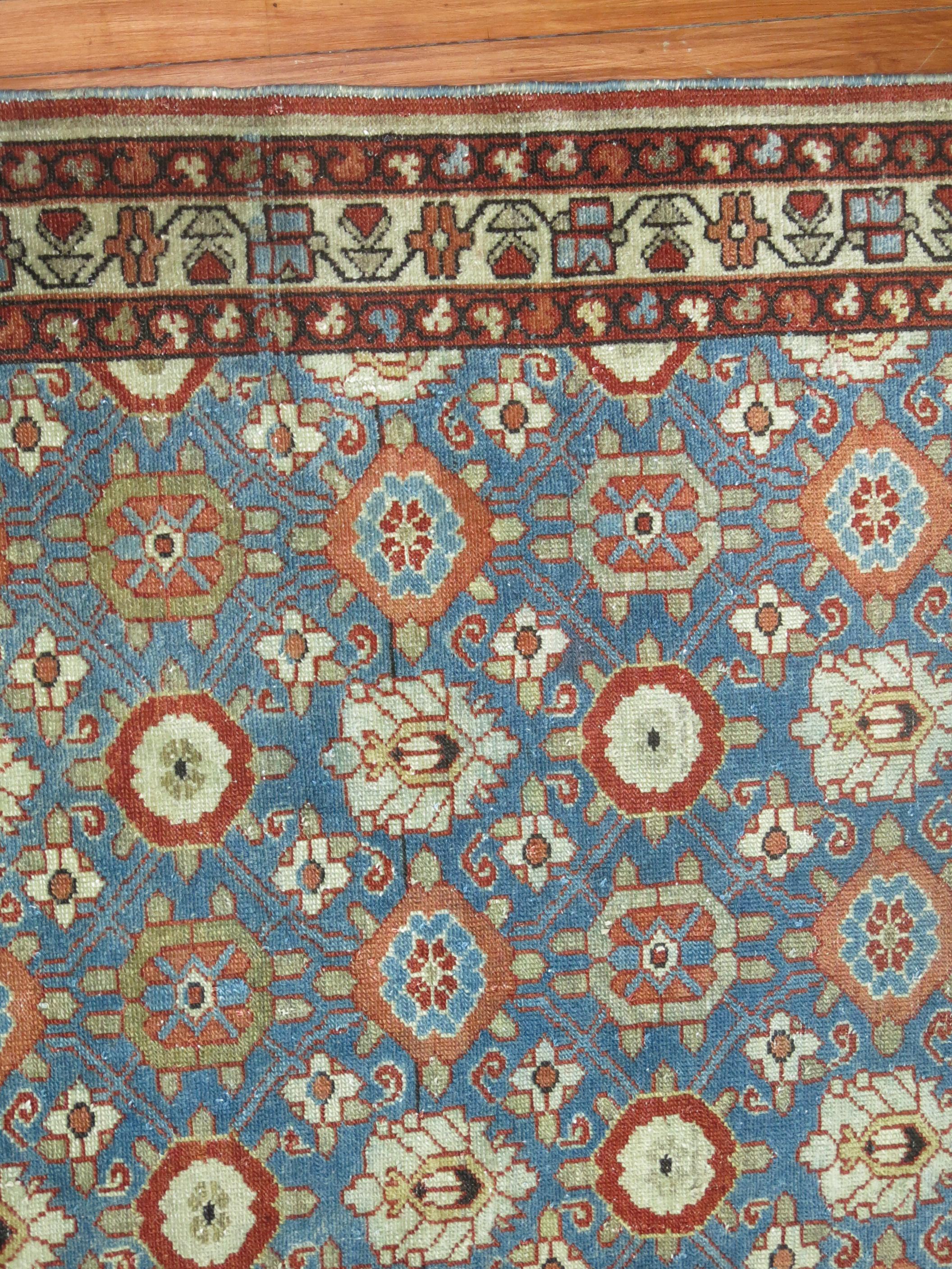An early 20th century Persian Malayer with a primitive all over design on a blue field.