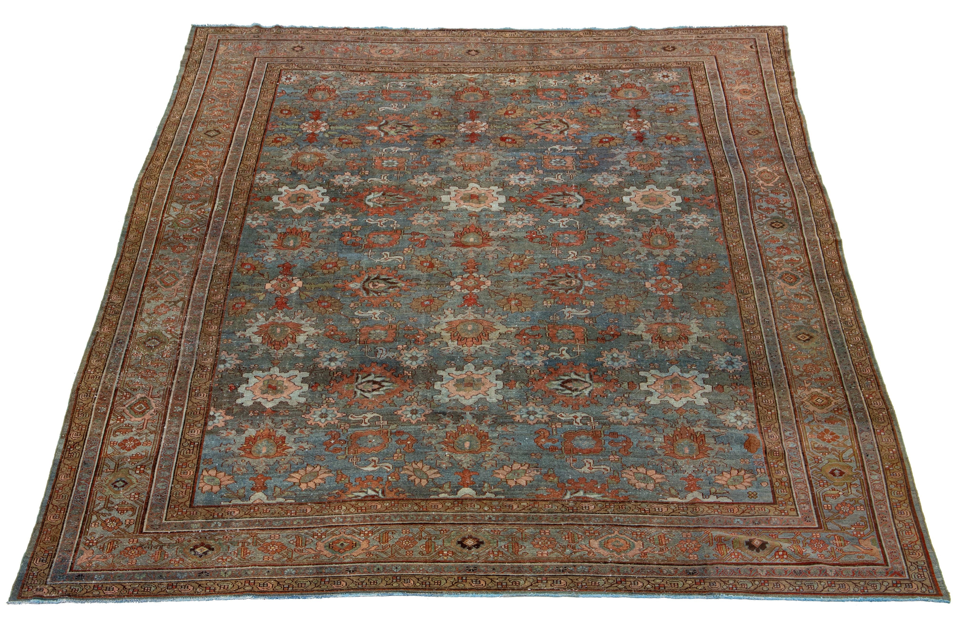 Beautiful antique Malayer hand-knotted wool rug with a blue color field. This Persian rug has a gorgeous all-over design with rust and brown accents.

This rug measures 11' X 14'.

.