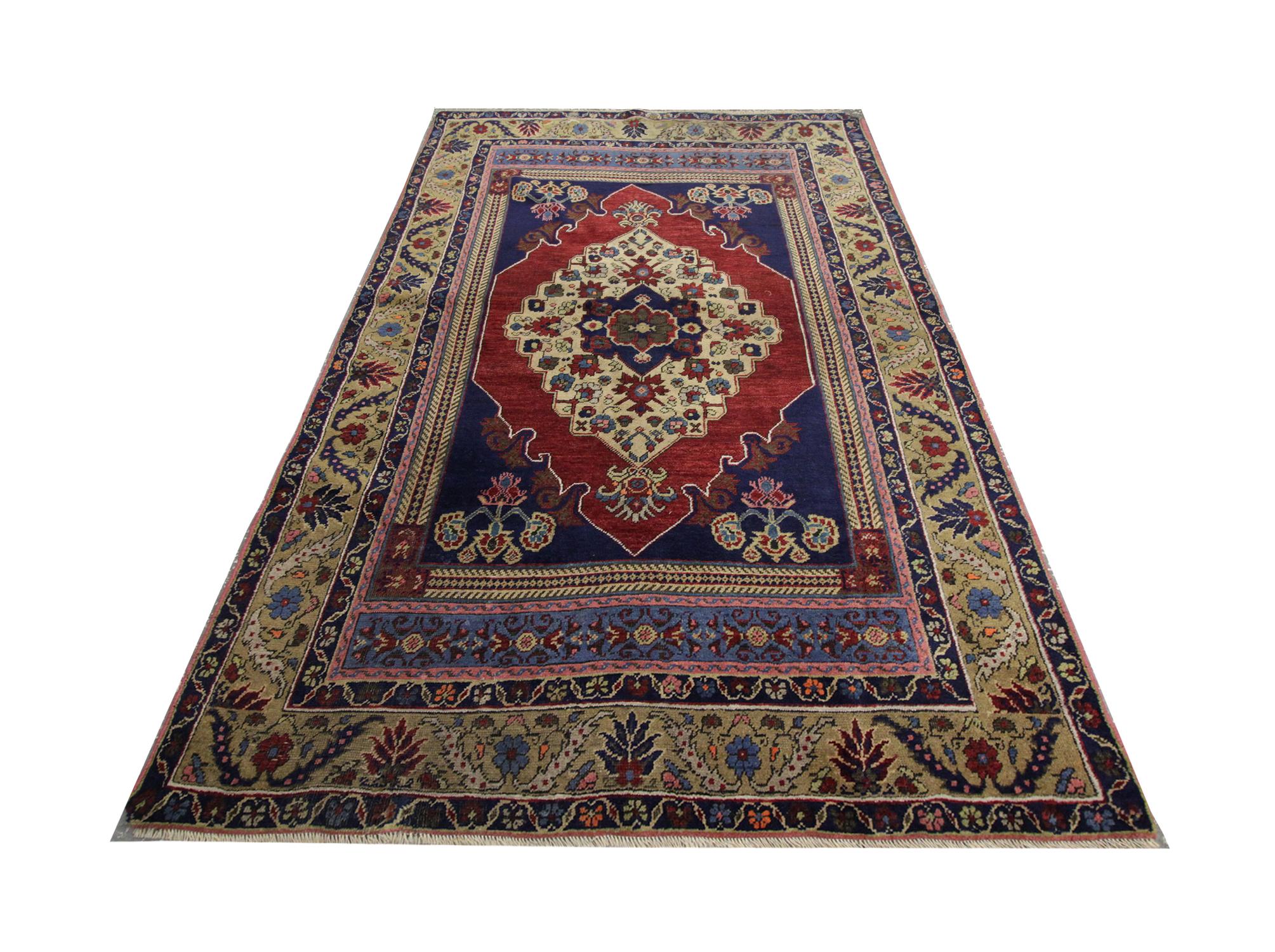 Traditional blue and red colorways have been handwoven into this high-quality antique Turkish rug, with a highly detailed central medallion design- handwoven in 1930 with hand-spun, vegetable-dyed wool, and cotton, by some of the finest artisans.