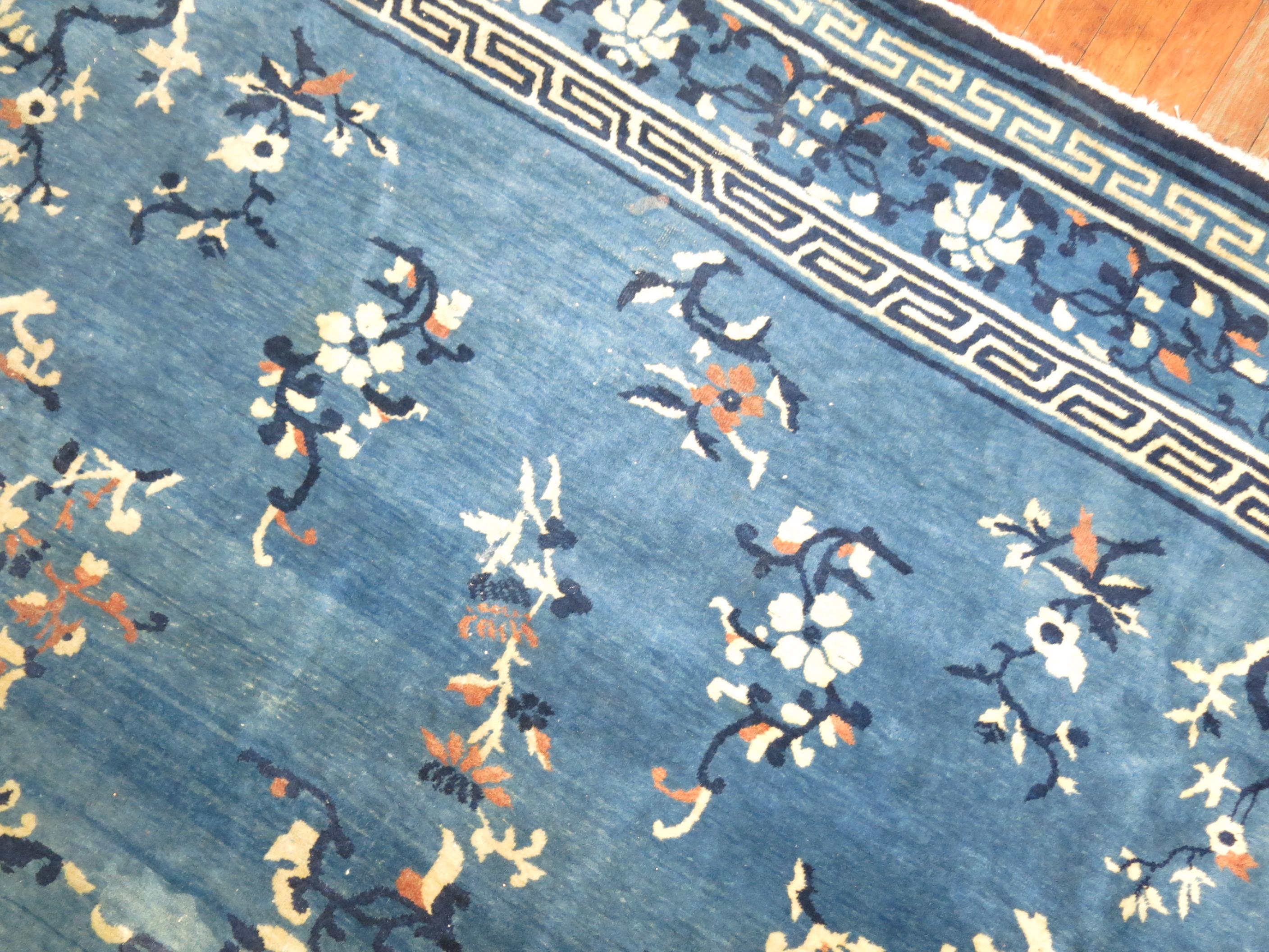 A room size Chinese rug in predominant blues and ivory.