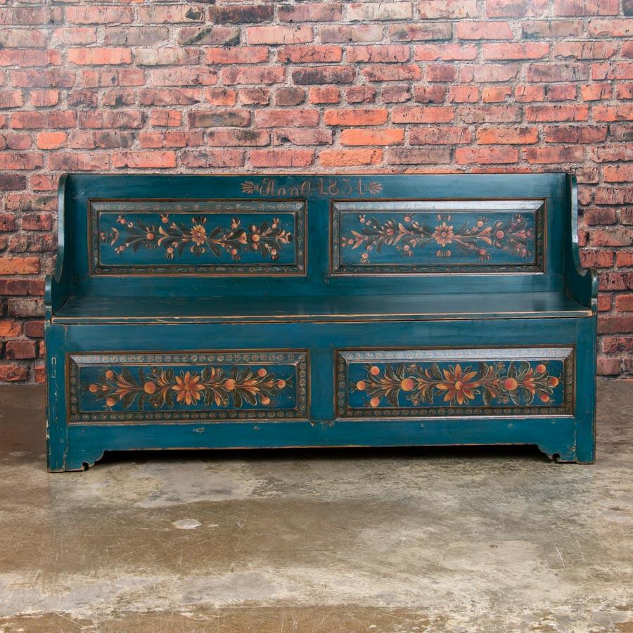 This delightful cottage style storage bench still maintains its original paint, with a traditional yellow and red floral and vine design on a dark blue background. It is a perfect size for an entry at just under 6 feet long, and still has ample