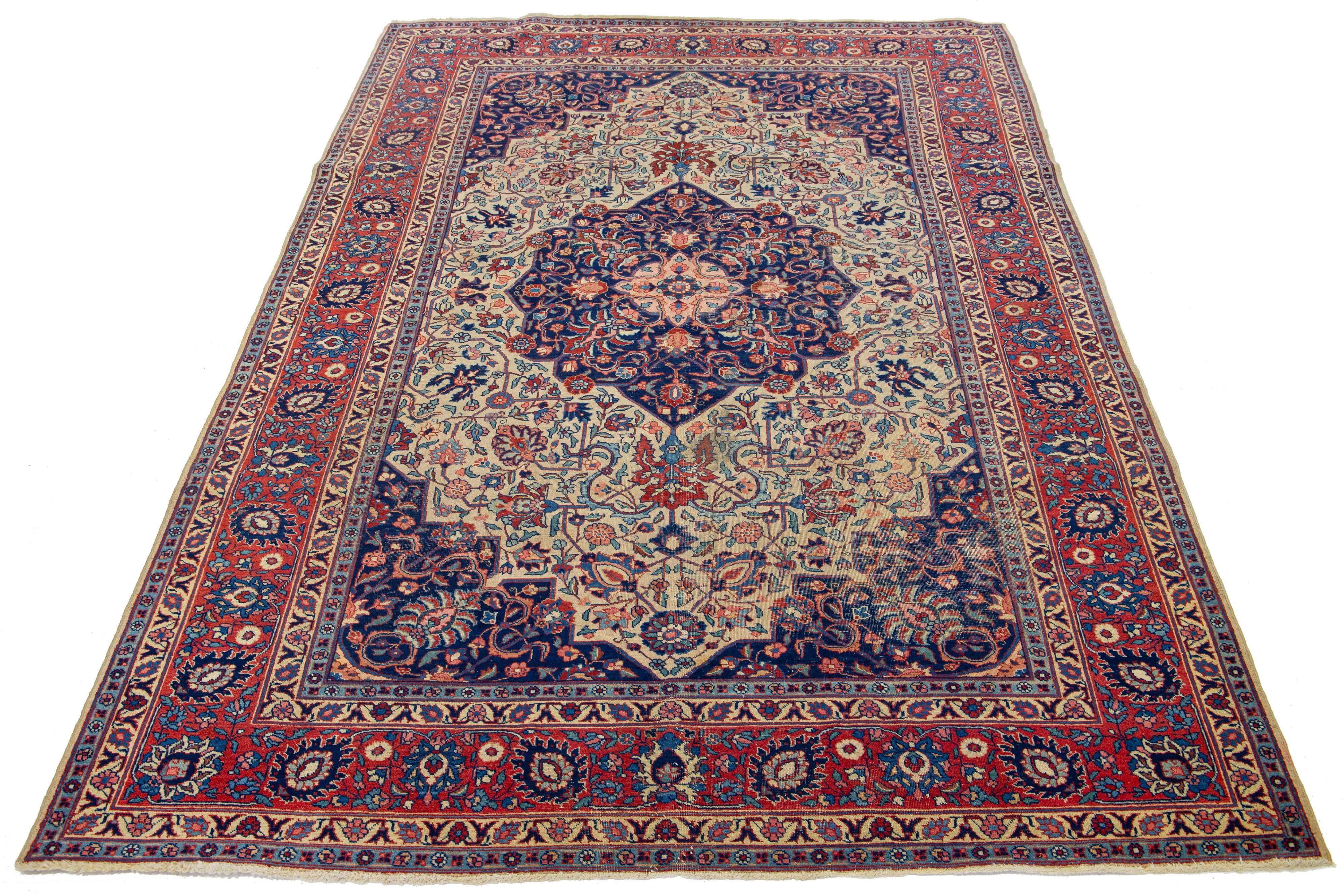 This beautifully handcrafted Persian Tabriz wool rug displays a classic floral pattern. The contrast created by the blue background accentuates the medallion floral design, which features shades of beige-tan, pink, and red.

This rug measures  6'6