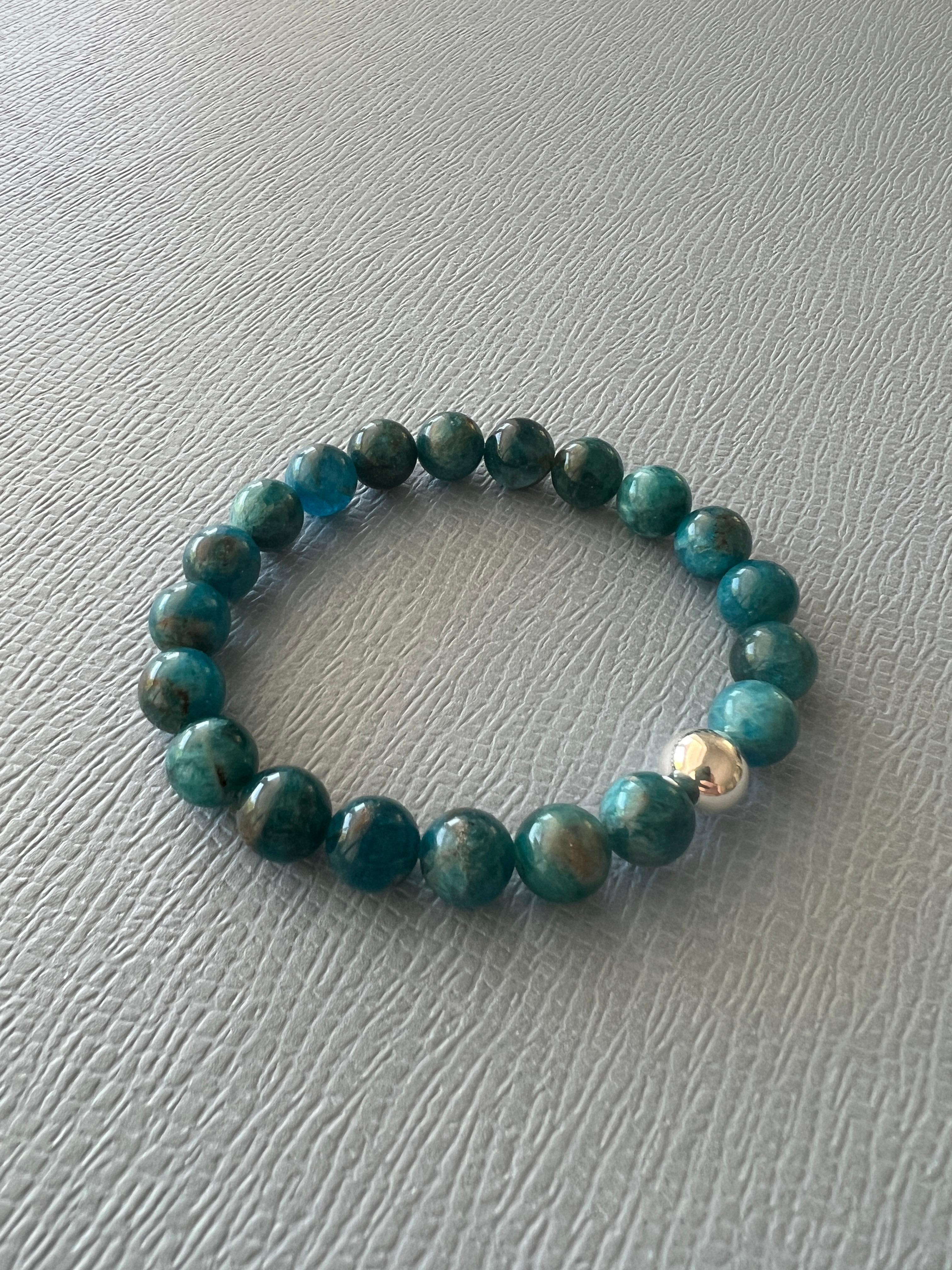 Blue Petroleum Apatite Round Bead Elastic Bracelet Silver Bead 

Made in Los Angeles

Designer: J Dauphin

The Natural Blue Apatite Round Bead Stackable Bracelet is an embodiment of geological history and metaphysical properties. Known for its deep,