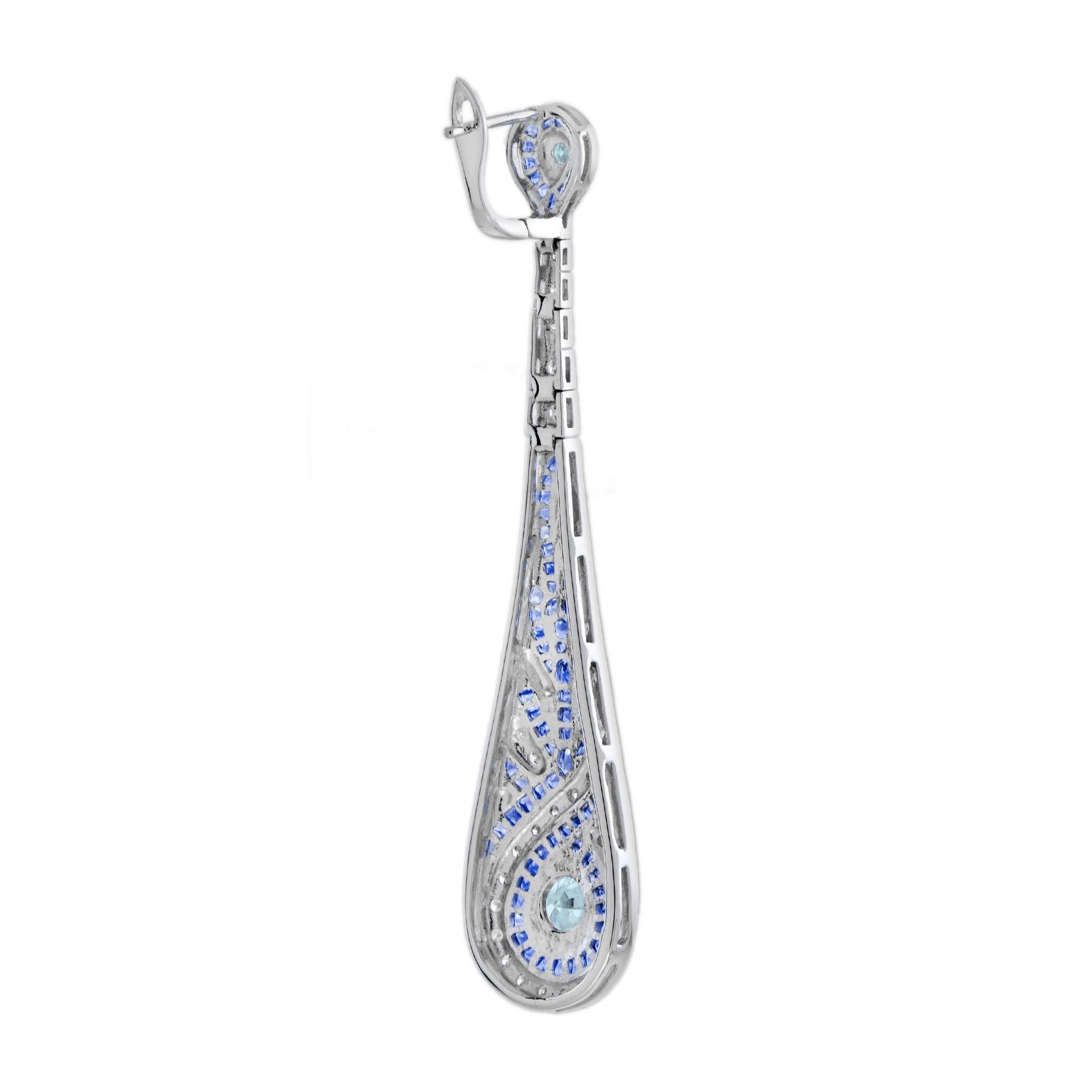 These fabulous Art Deco style ear drops, fabricated in white gold, are stunning. Measuring 63 mm. long, a pair of bright and shining aquamarine together weighting 0.90 carat, each ornamented with smaller diamonds bordered by French cut blue
