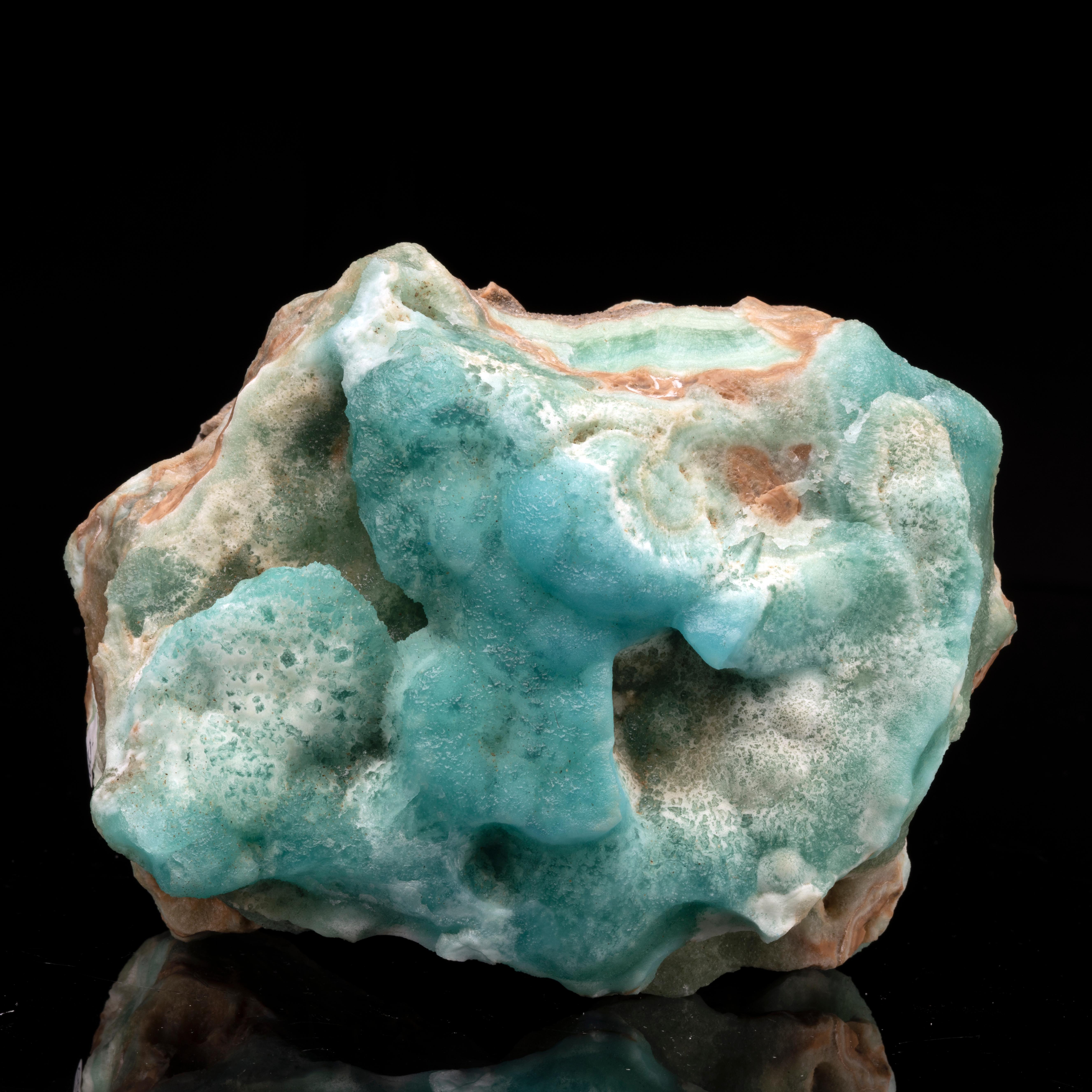 This rocky teal, white, and sandy reddish-brown freeform find is perfect for the discerning mineral enthusiast. The crystallized blue form of the calcium carbonate mineral is very sought-after and it's unusual to find pieces with such great luster