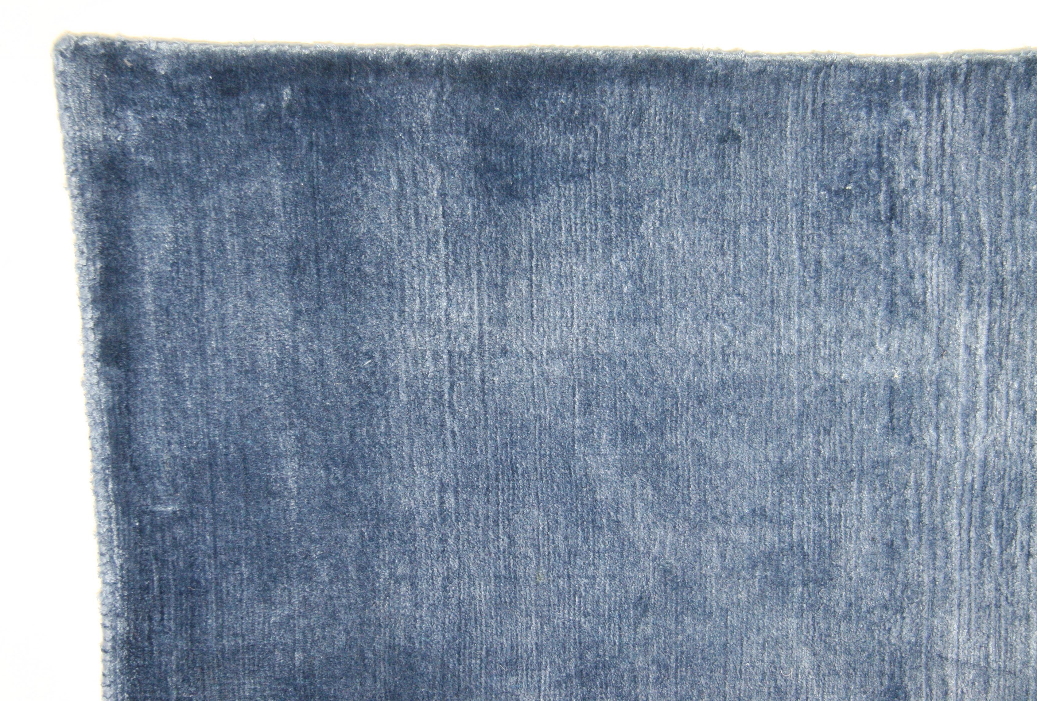 Plush, dense pile medium blue area rug. Viscose. Made in India using natural vegetal dyes.