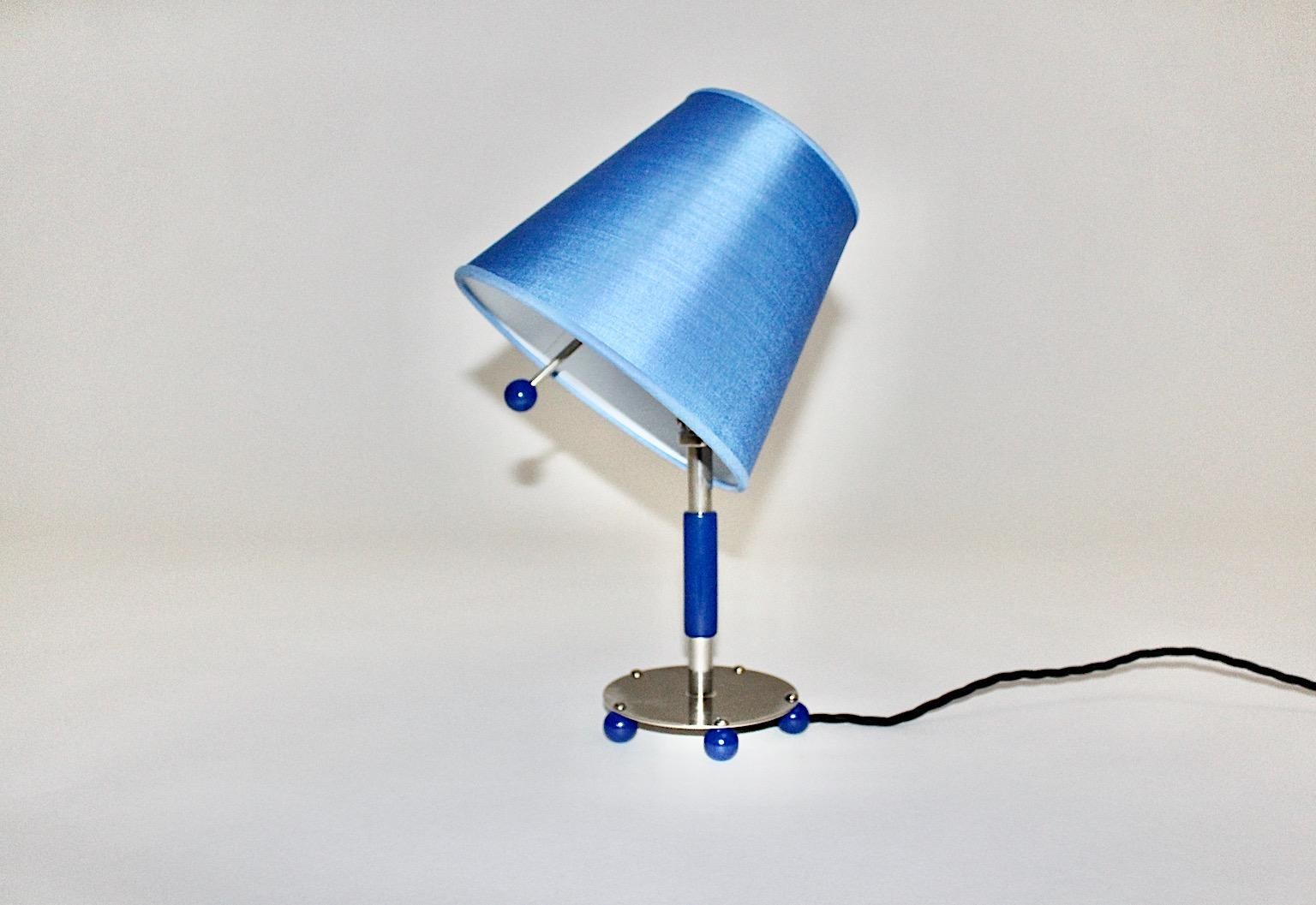 A blue Art Deco vintage chromed tube metal, which features also blue wooden details. The renewed lamp shade shows a funky blue color tone. A great feature is the adjustable shade function, at the shade so the light shine is easy to direct.
With few