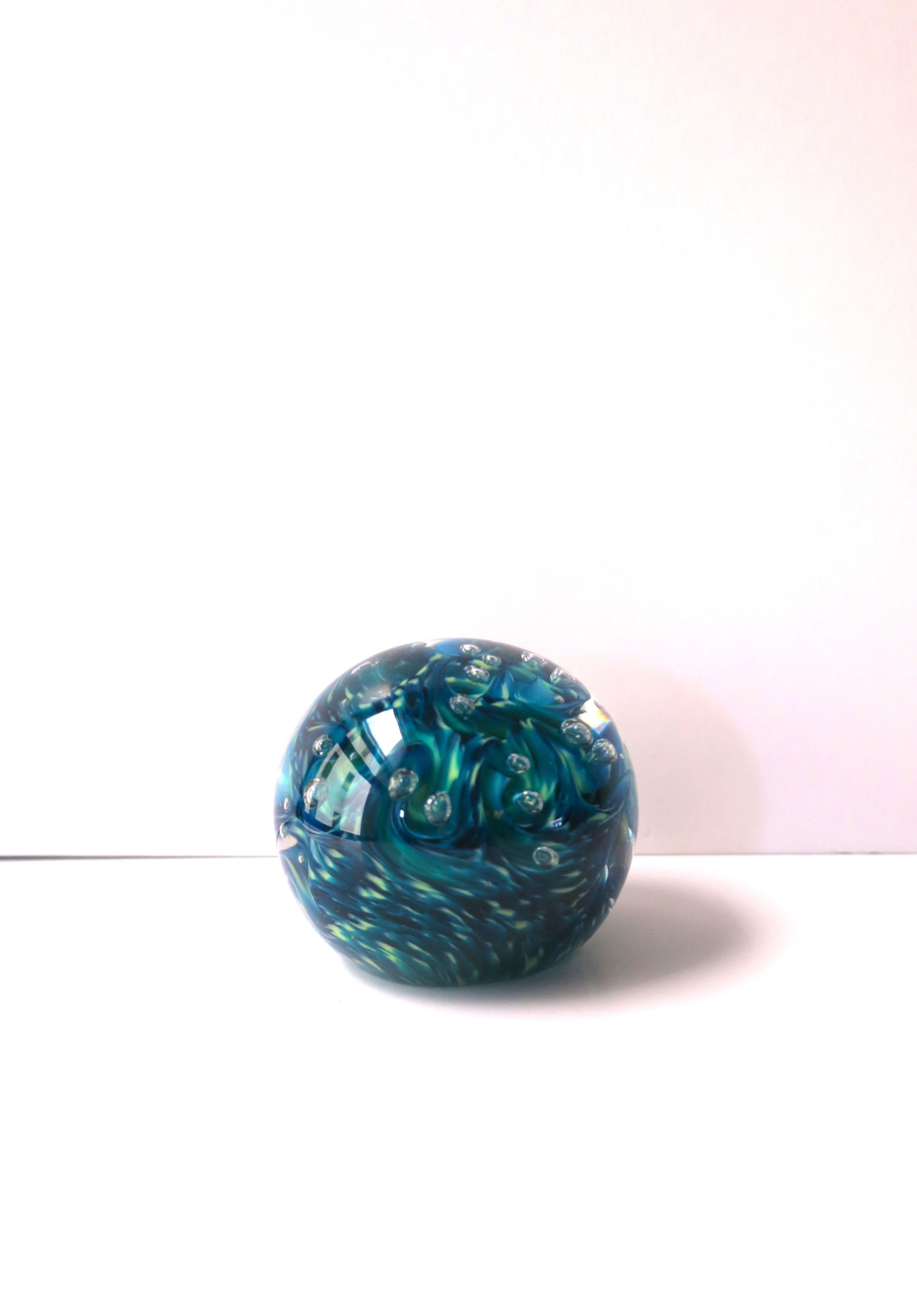 A substantial blue art glass ball sphere paperweight or decorative object with bubble design, signed by artist, 2021. A beautiful ball sphere paperweight with swirls of blue, green and shimmering art glass with bubble design, hand-made by artist