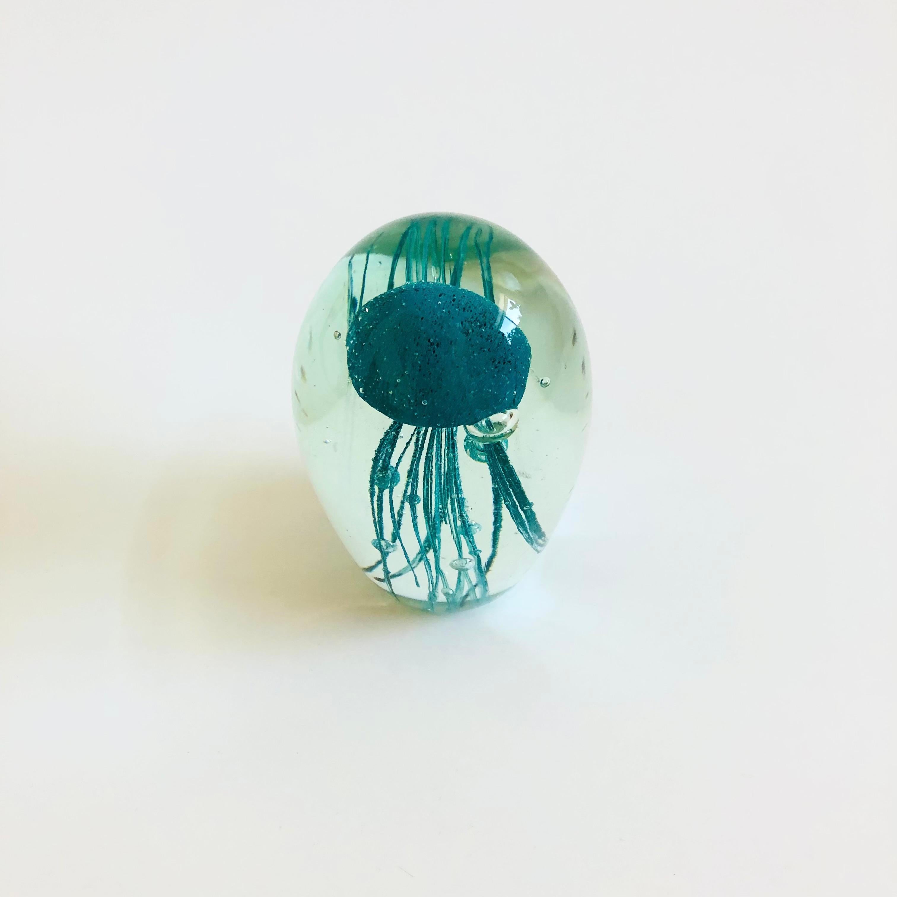 A vintage art glass jellyfish. Clear with a teal blue jellyfish in the center. A great sculptural accent with beautiful detailing formed to create the details of the jellyfish.

