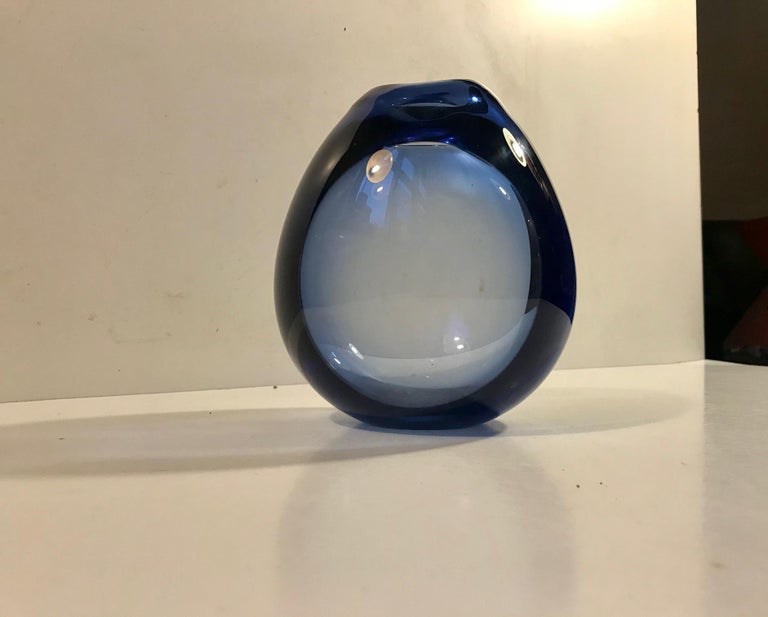 Organically shaped (almost fluent) light blue art glass by Danish designer Per Lütken. Created at Holmegaard Studio in the early 1960s. Hand blown thick and heavy glass.