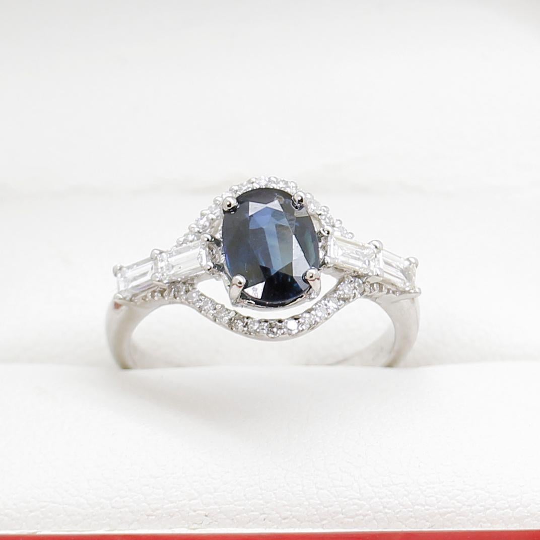 Blue Australian Sapphire & Diamond Engagement Ring, Estate

18ct White Gold ring, narrow, low half round, tapered shank with open back 4 claw with a fancy halo setting, polished finish, stamped 750.

The item contains:

One claw set oval shaped