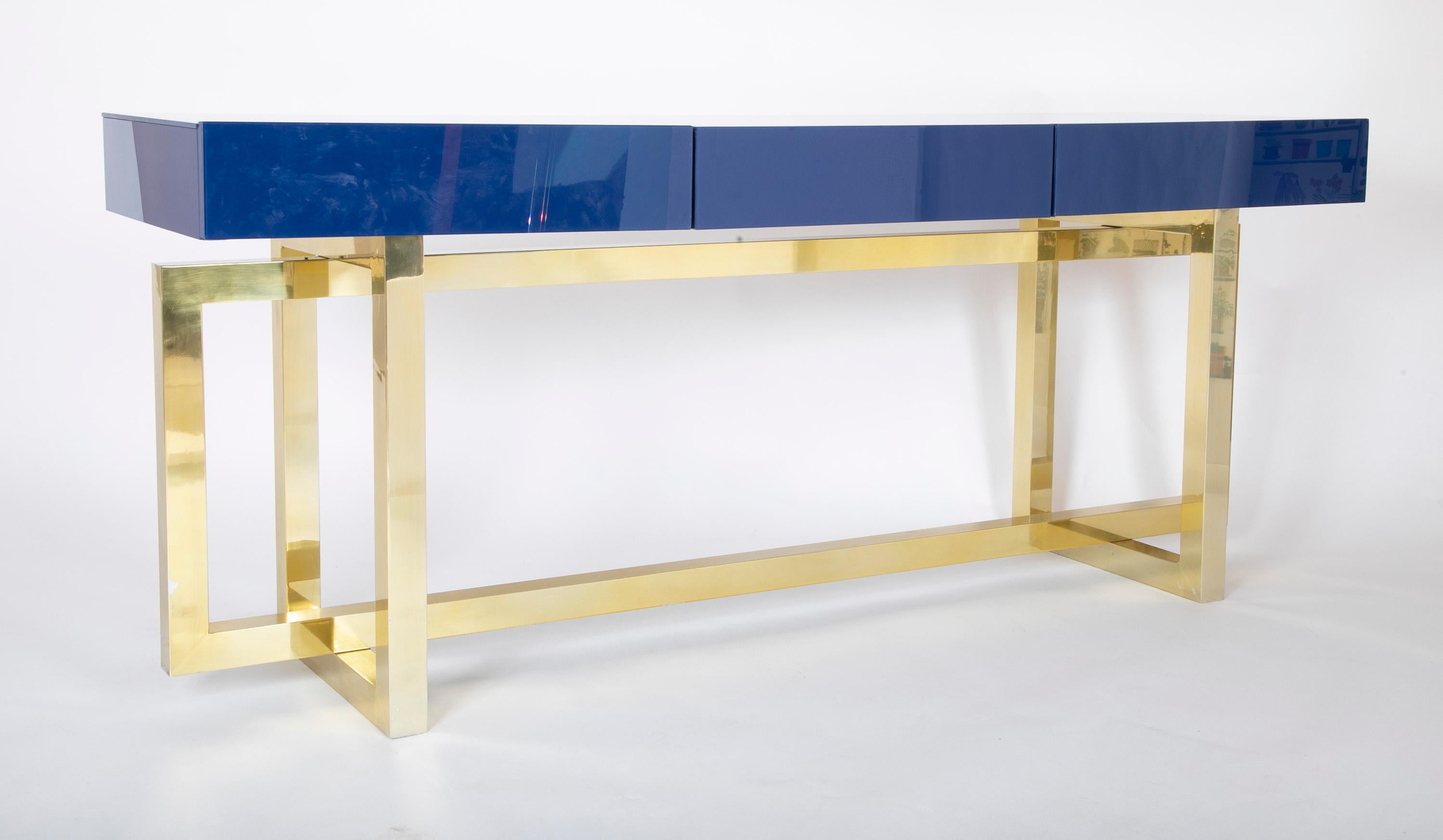 Romeo Rega console table.  Brilliant blue glass with brass base.  Glass over wood construction with three drawers.  Italy.  1970's.

