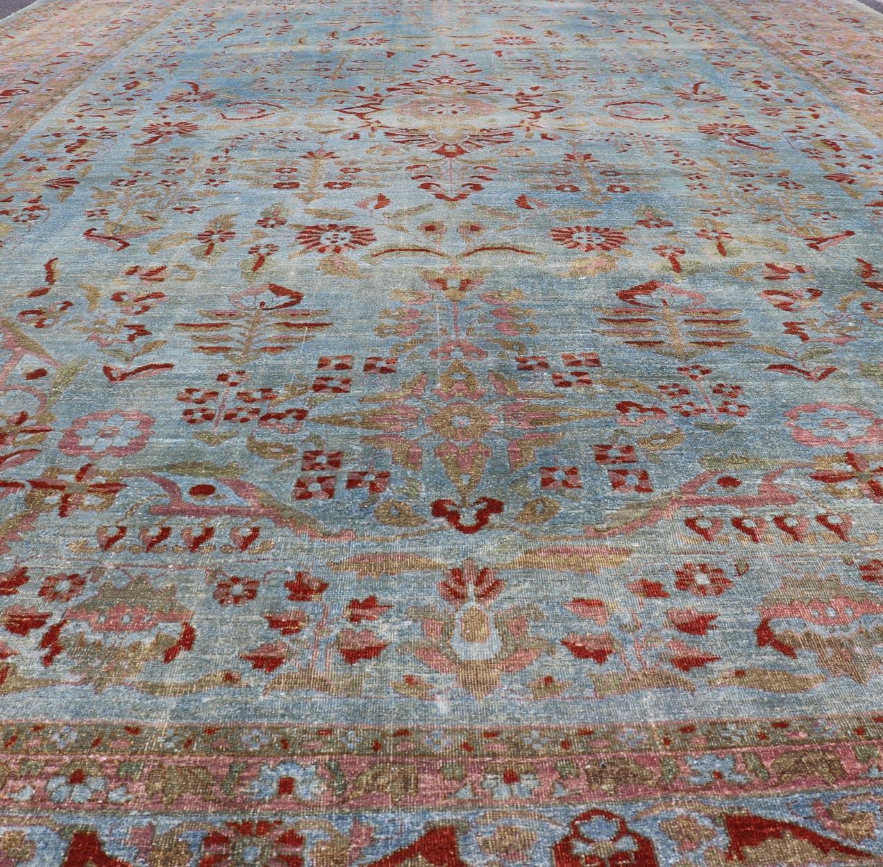Antiker persischer Mohajerah-Teppich mit blauem Hintergrund und Lachsblau, Grün und Rot (Wolle) im Angebot