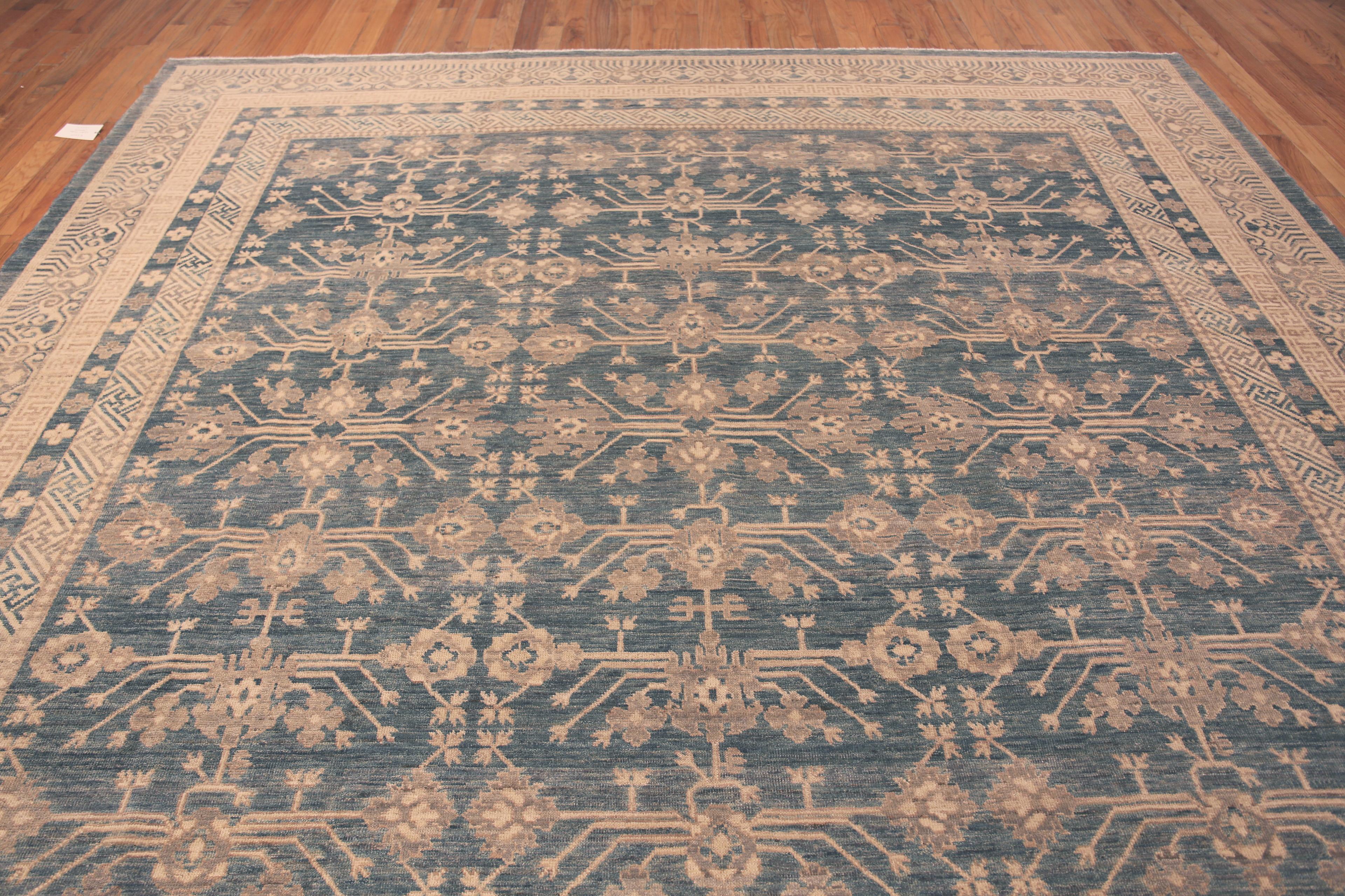 Blue Background Modern Khotan Rug, Country of Origin: Afghanistan. Circa date: Modern. Size: 11 ft 8 in x 12 ft (3.56 m x 3.66 m)
