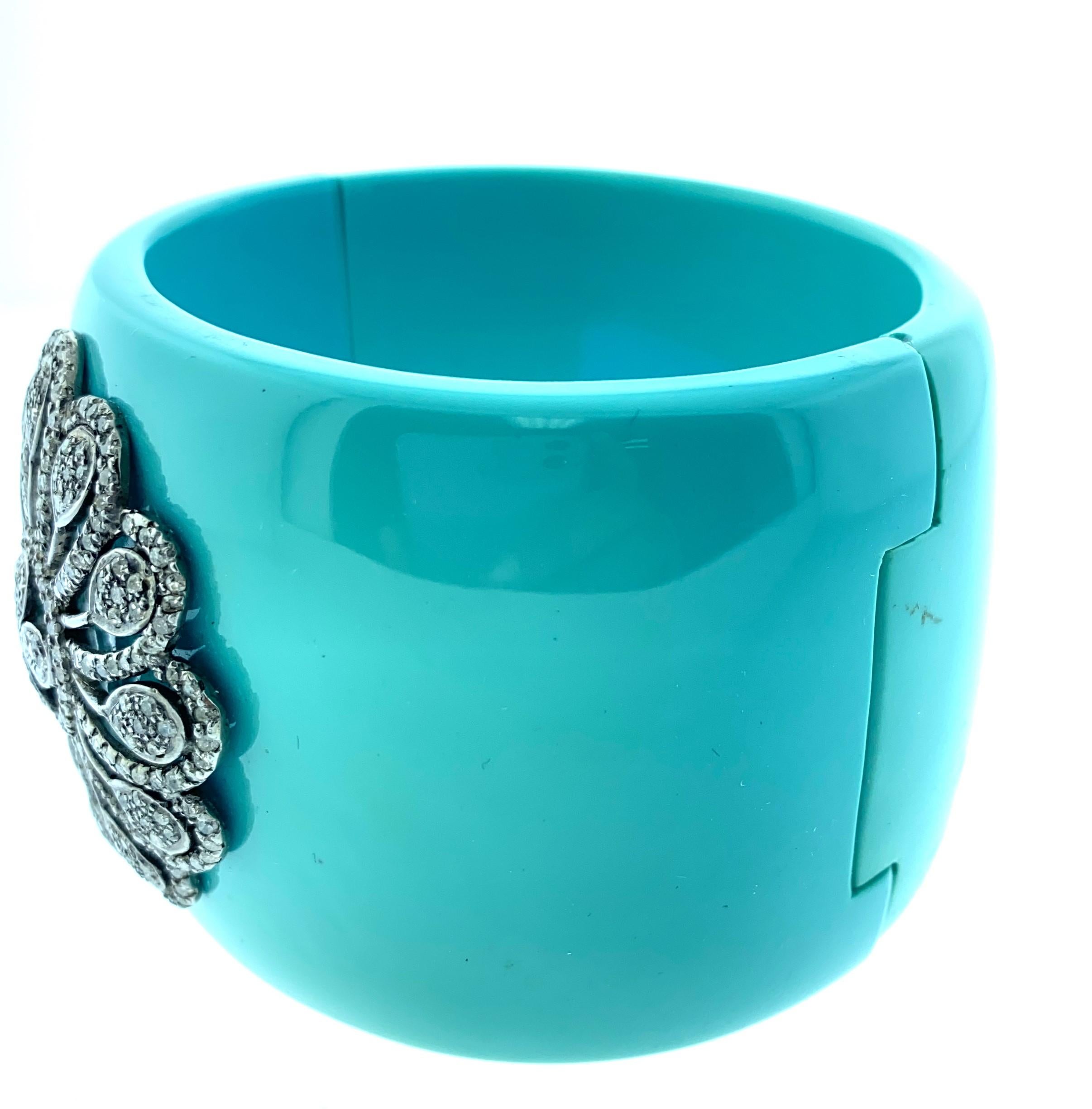 Blue Bakelite 3.75 ct Champagne Diamond Bangle set in Oxidized Sterling Silver. The bangle has an easy open and close safety. It is sturdy and secure bangle. The bangle has a diamond flower set in the front of the bangle.
Diamonds : 3.75