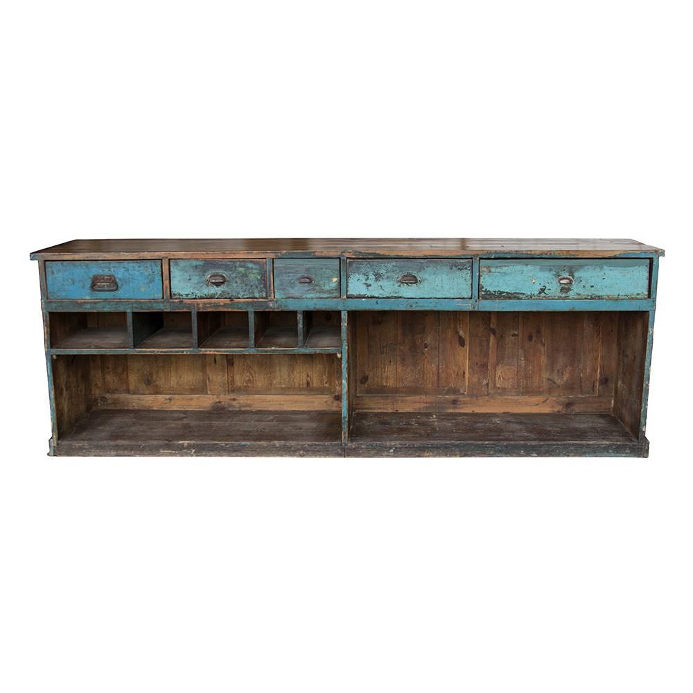 Cerulean and sky blues come together perfectly with a earthy hues of a natural wood top. The bead board accent panels on the front are interspersed with rustic pilasters that have hand-carved capitals. The back of the counter is filled with both