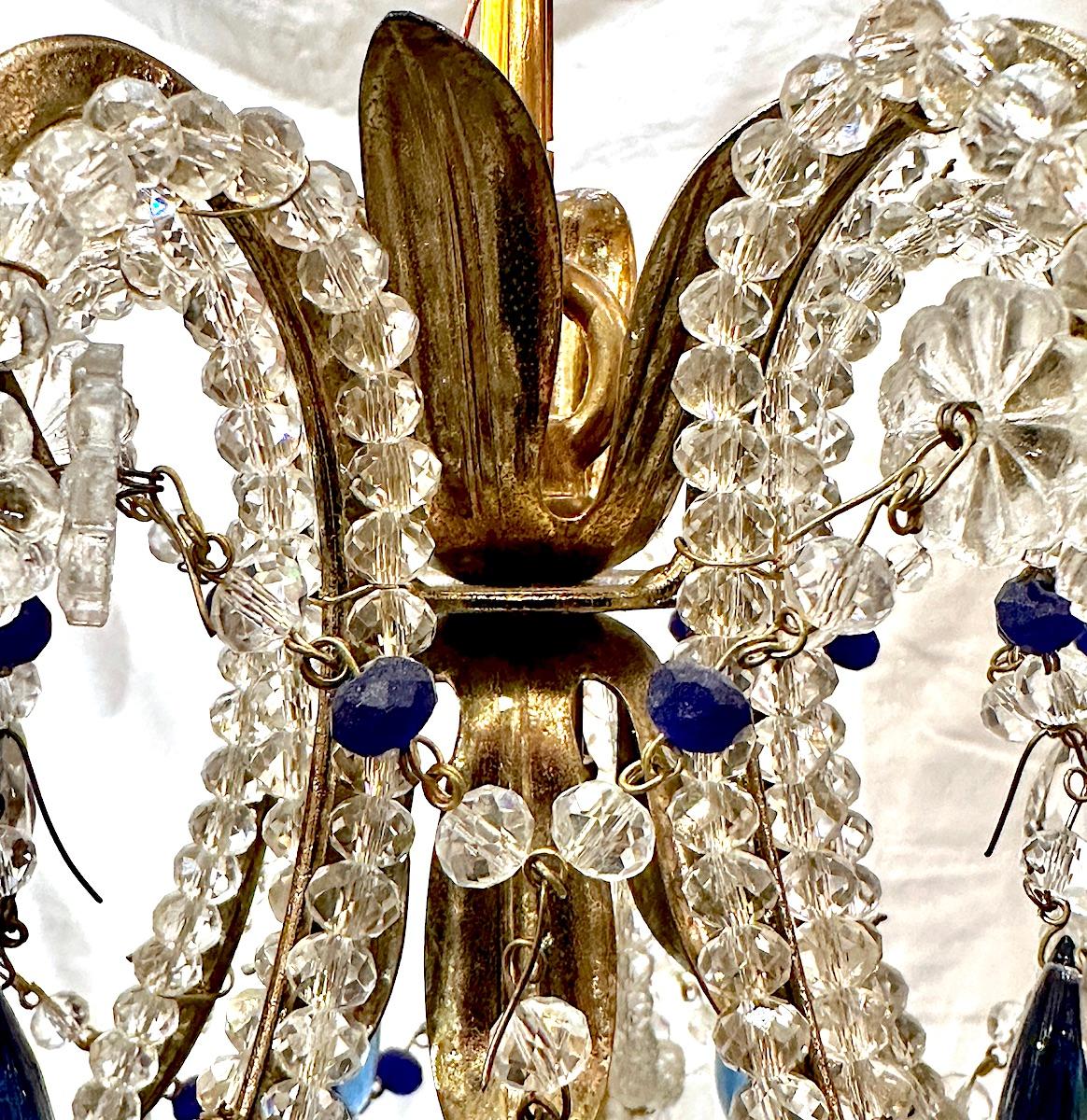 A circa 1950's French beaded crystals light fixture with three lights.

Measurements:
Drop: 21