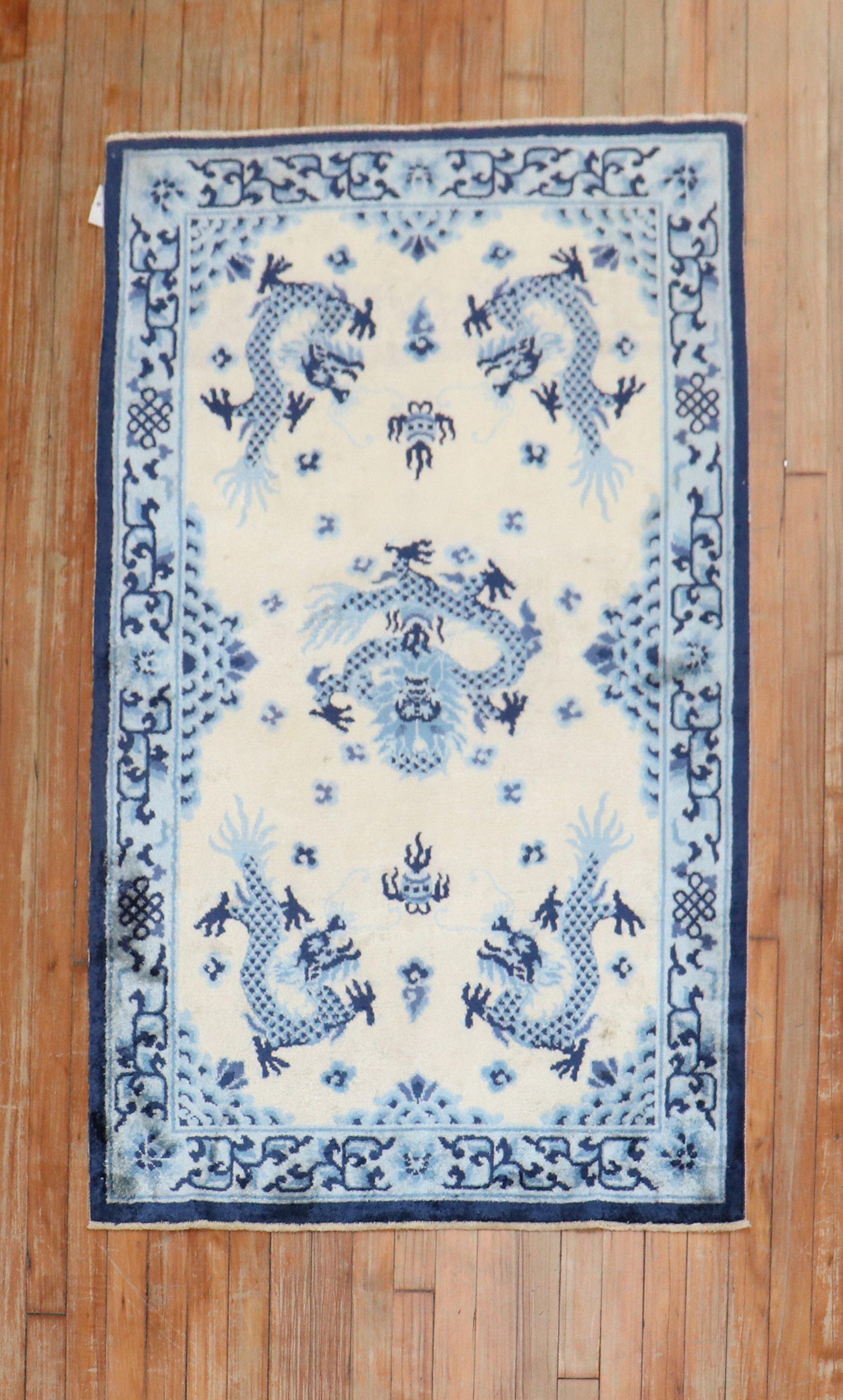 A late 20th-century Chinese Silk rug in beige, light blue and navy

Measures: 3' x 4'11''.