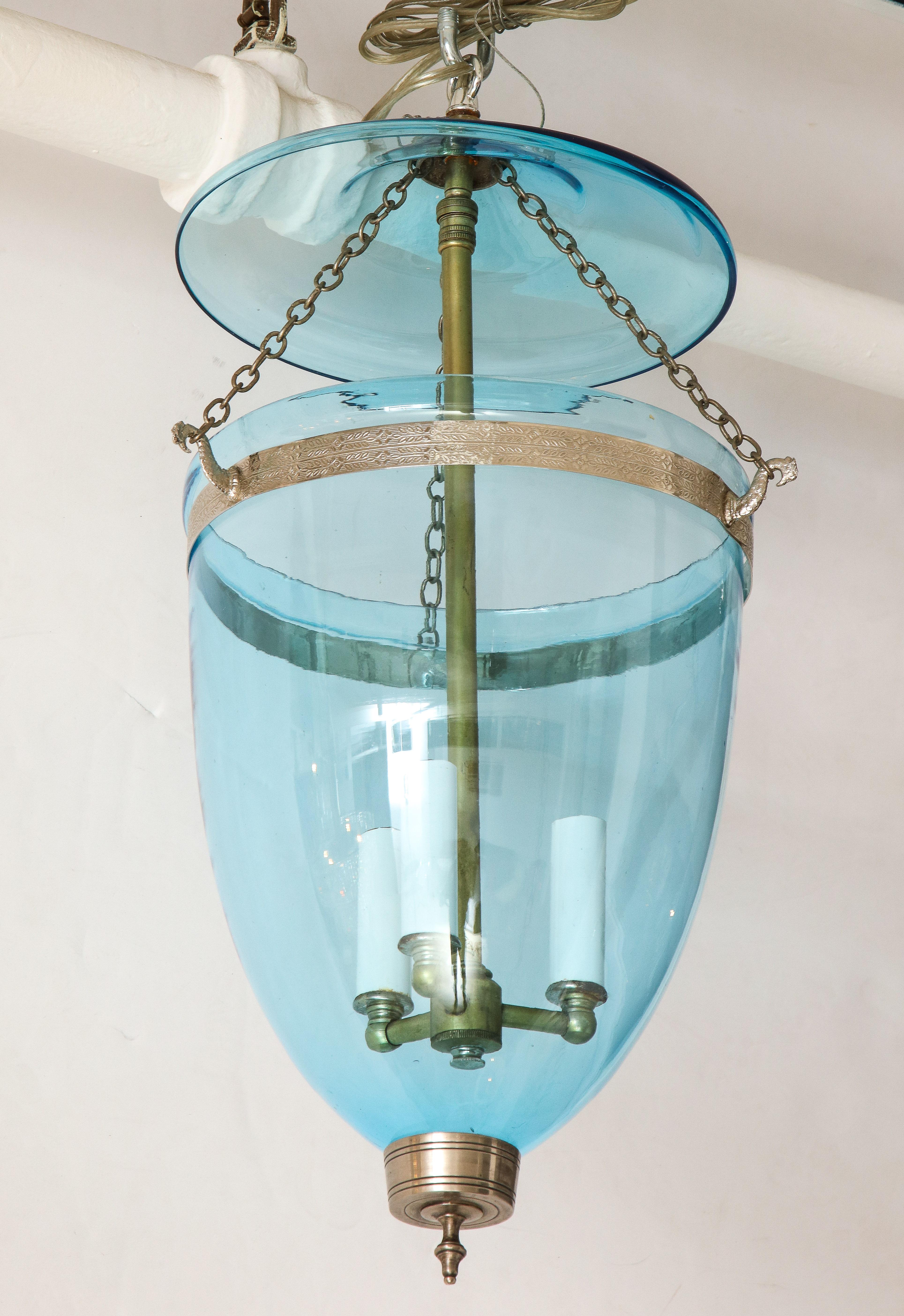 A lovely small glass bell jar lantern with three lights in a stunning blue--perfect for a small entry or powder room!