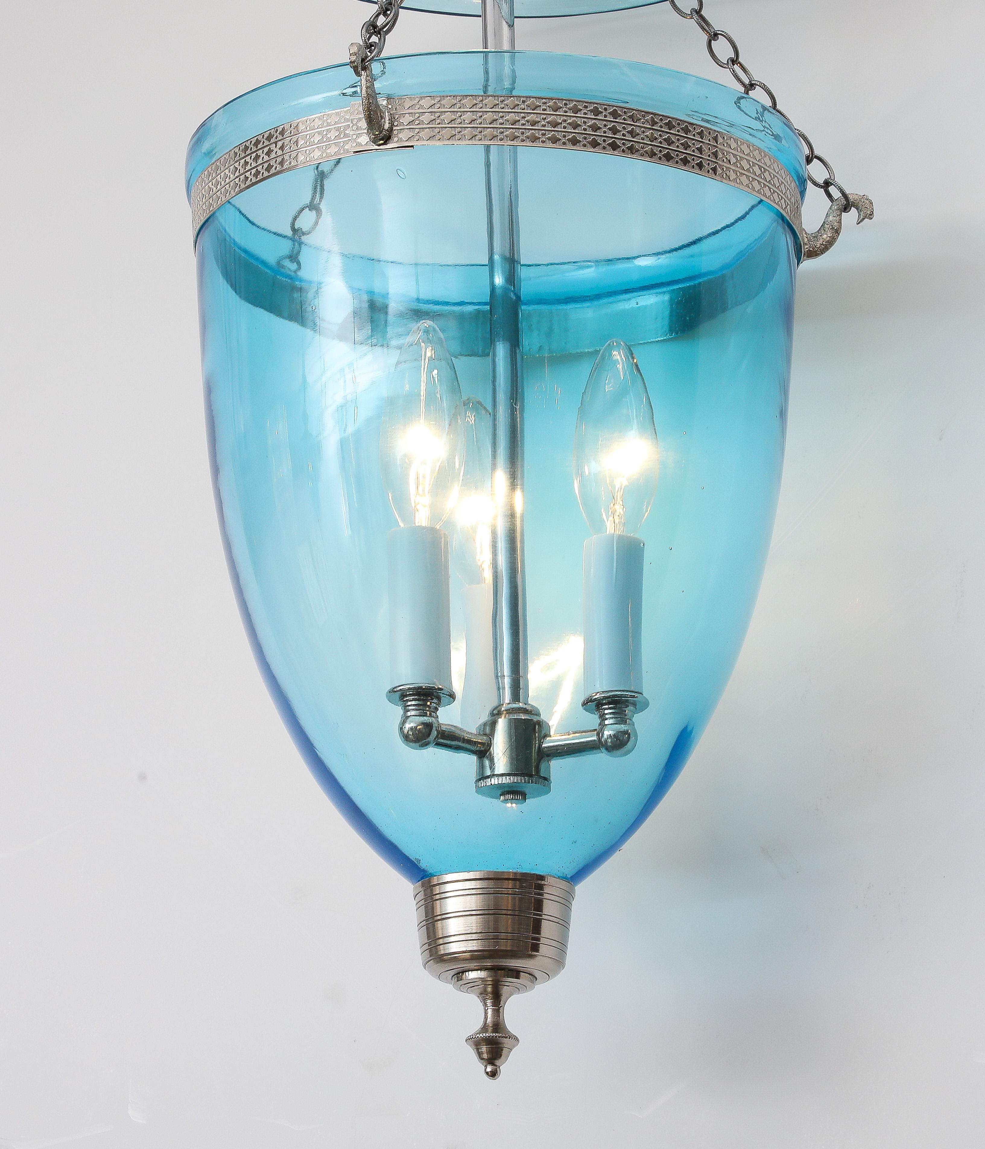 A lovely small glass bell jar lantern with three lights in a stunning blue--perfect for a small entry or powder room!
