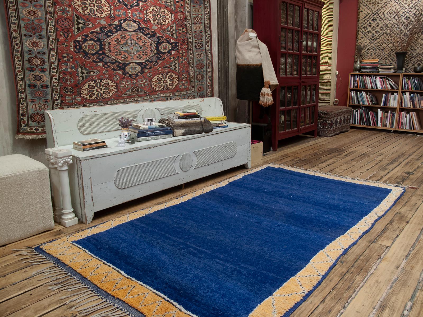 An alluring field of blue framed by a pale yellow border - a delightful Berber rug from the foothills of the western Middle Atlas Mountains.