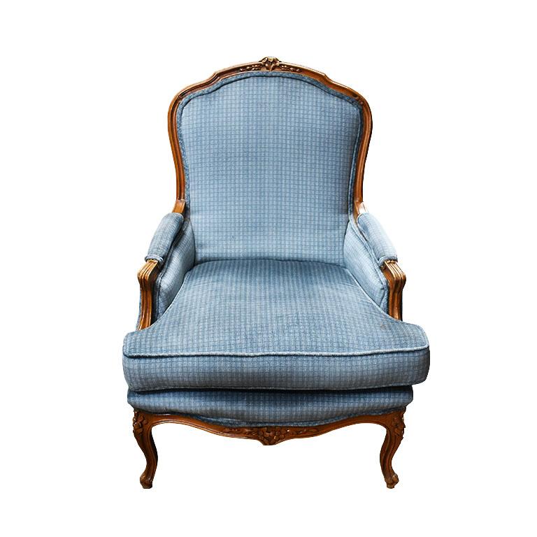 A pair of blue Bergère armchairs with carved wood details. A lovely set of baby blue arms chairs with a removable seat cushion. The legs are carved wood cabriole style, and feature a flower motif at the top. The back is fully upholstered in the same