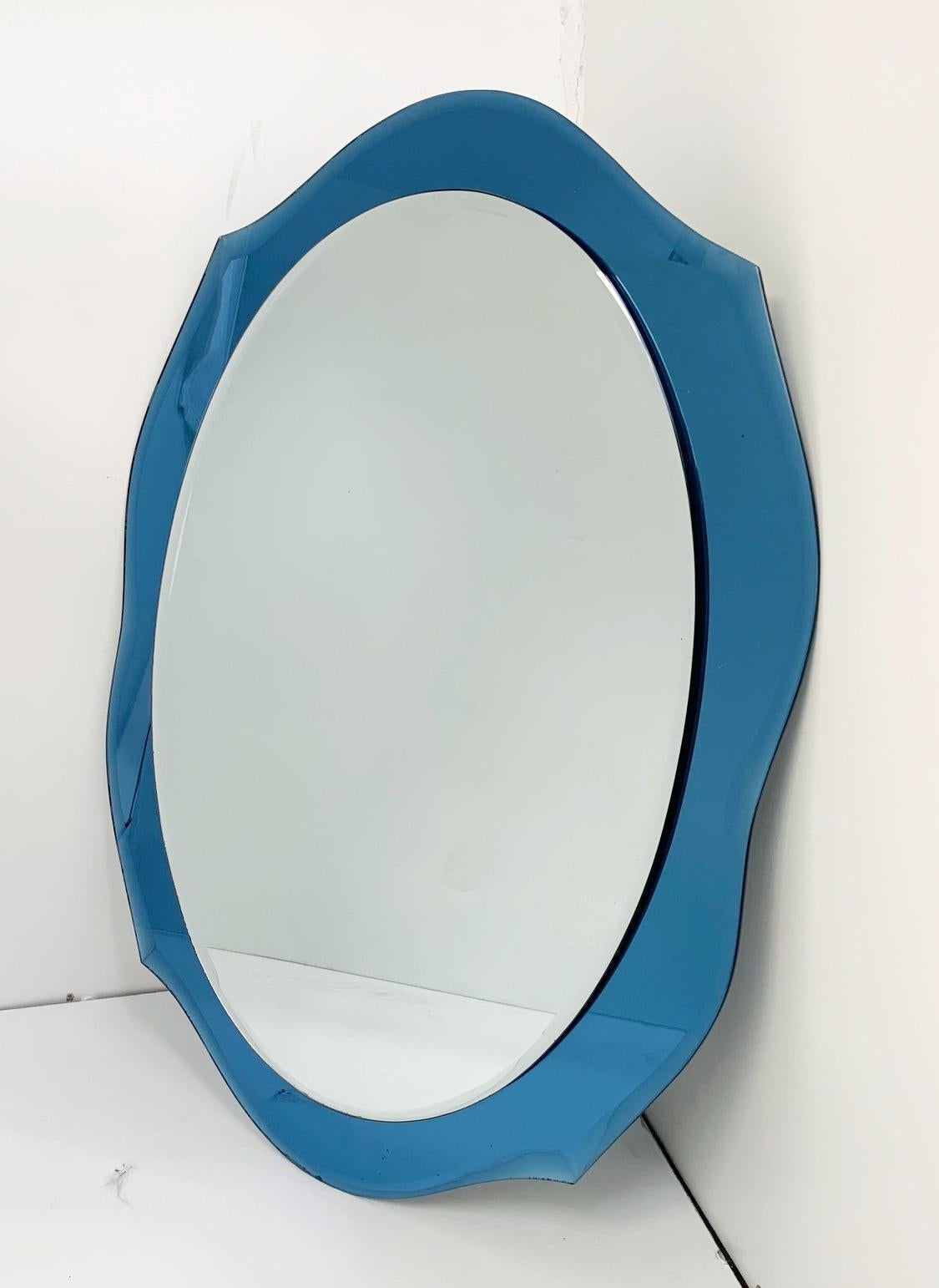 Vintage mirror with blue beveled glass by Cristal Art / Made in Italy in the 1960s
Measures: Height 30.5 inches, width 23 inches, depth 2 inches
This item ships from Italy.
  