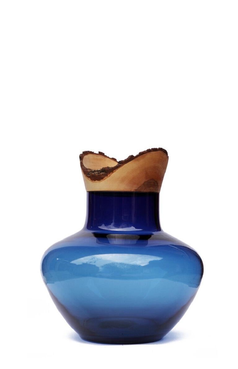 Blue Big Bloom stacking vessel, Pia Wüstenberg
Dimensions: D 50 x H 40
Materials: glass, wood

A sculptural masterpiece, the great scale version of the Bloom Stacking Vessel, crowned with a big wooden bowl.
Handmade in Europe: hand blown glass
