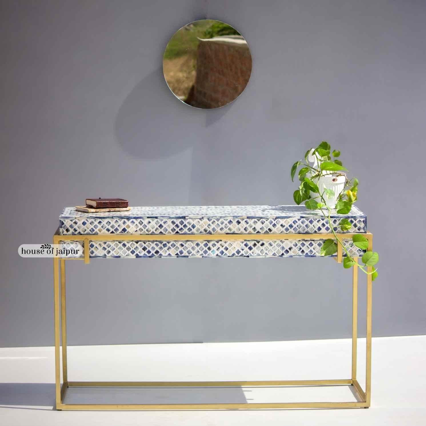 A striking fusion of craftsmanship and contemporary design, this Bone Inlay Console Table features a vibrant blue geometric pattern inlay meticulously handcrafted by skilled artisans. Each dyed bone tile is individually cut, shaped and placed to