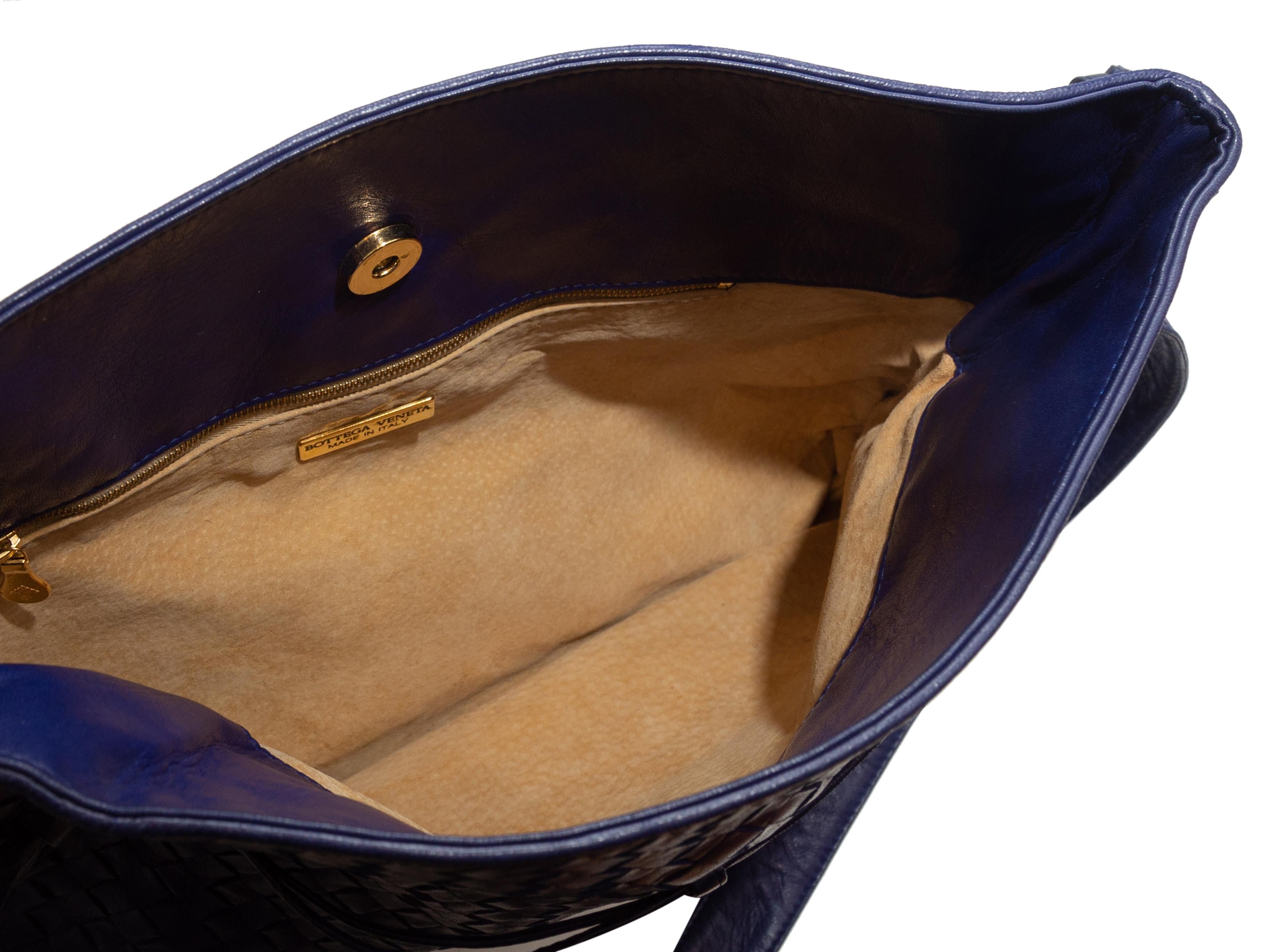 Product details: Vintage blue Intrecciato leather shoulder bag by Bottega Veneta. Gold-tone hardware. Interior zip pocket. Adjustable shoulder strap. Magnetic closure at top. 13