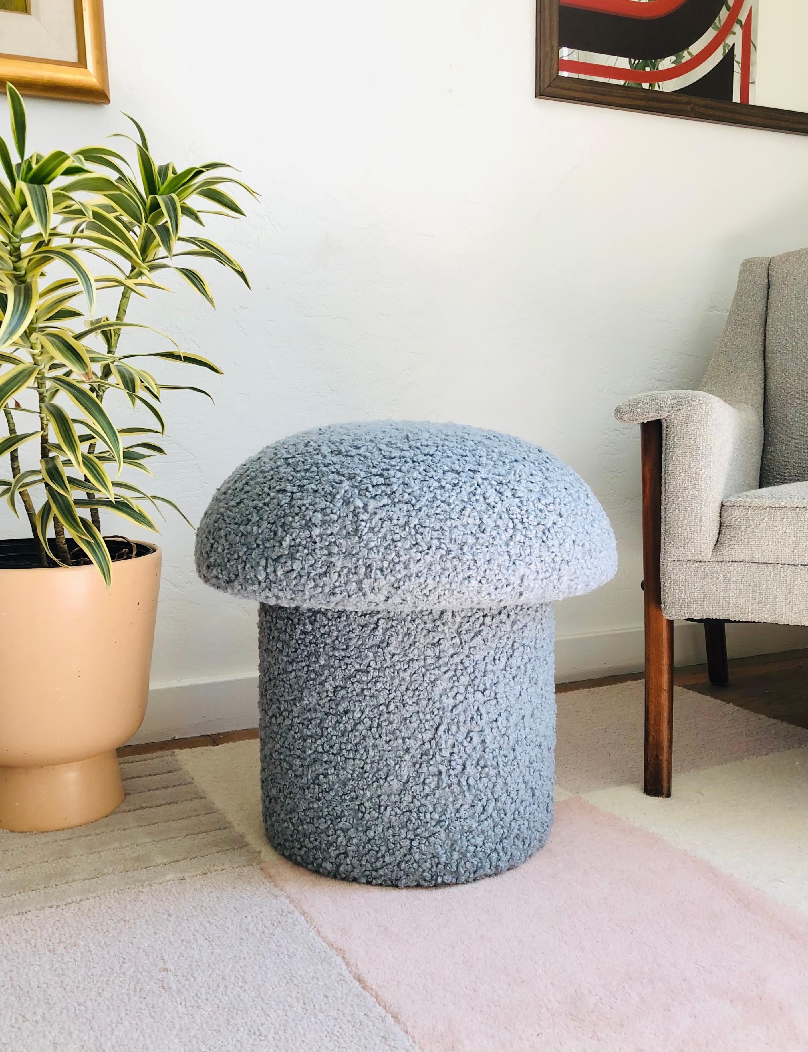 A handmade mushroom shaped ottoman, upholstered in a light blue colored curly boucle fabric. Perfect for using as a footstool or extra occasional seating. A comfortable cushioned seat and sculptural accent piece.
Mushroom ottomans are made to