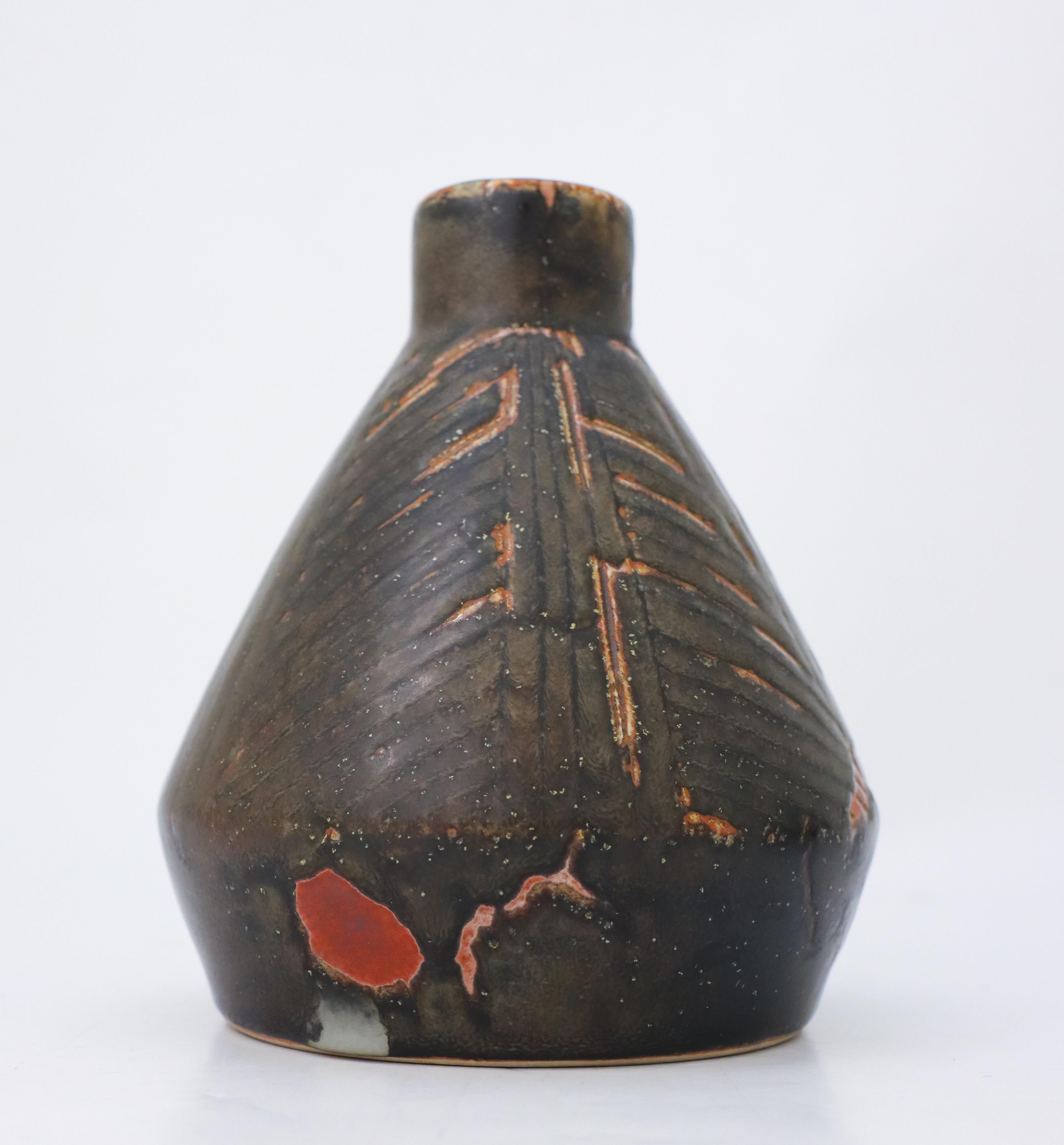 A black vase with some minor red color designed by Carl-Harry Stålhane at Rörstrand, It is 18 cm (7.2