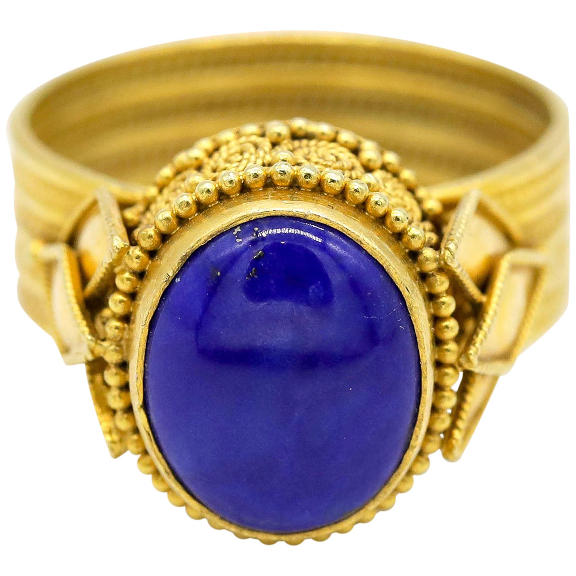 Blue Cabochon Oval Shape Gemstone 22 Karat Yellow Gold Ring 

Gemstone has a long and fascinating history of being highly coveted and prized as a very special and unique gemstones. This rare, -carat blue Cabochon Oval Gemstone, possesses a delicate