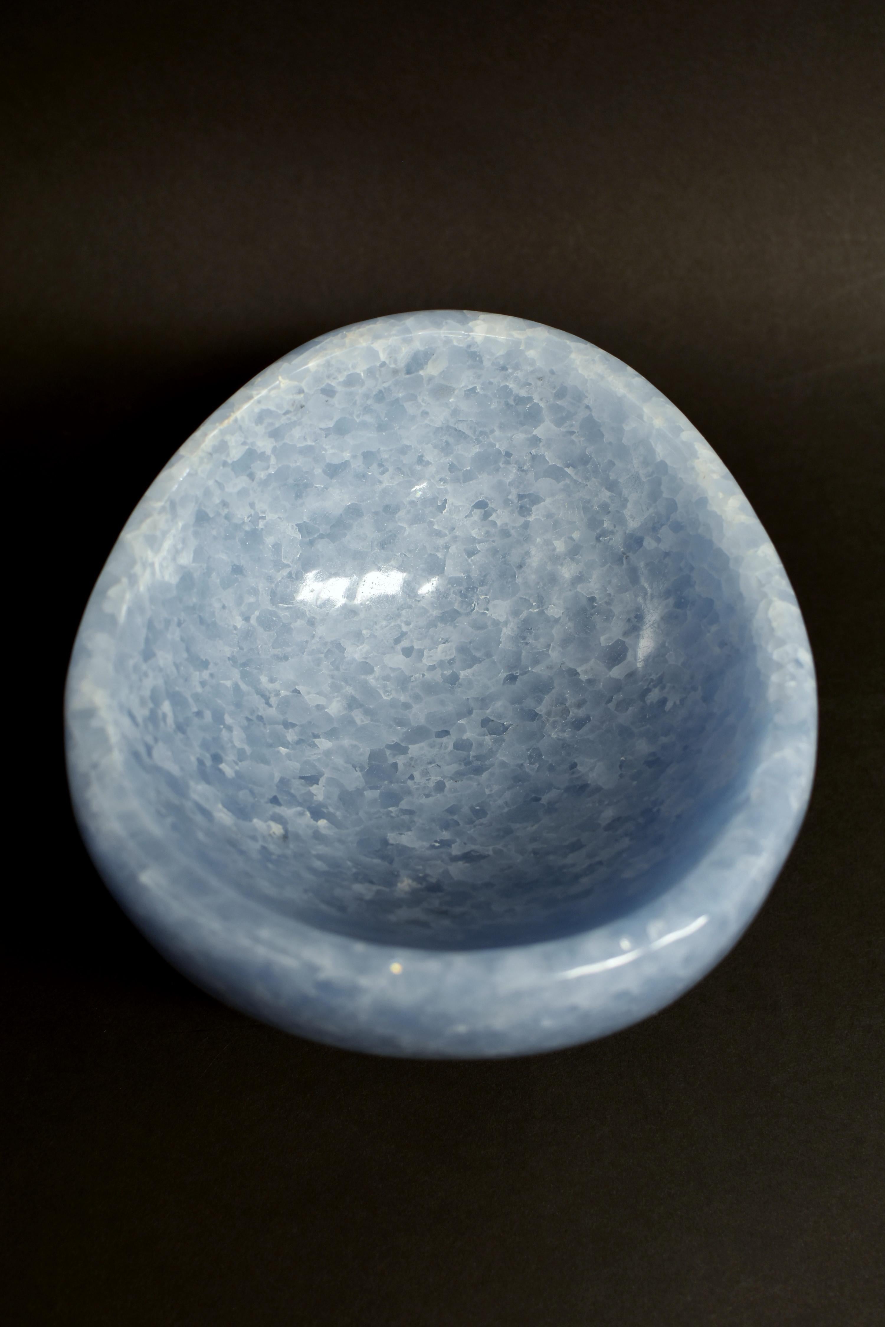 A finest-grade, natural blue calcite bowl in organic form. The bowl has the most beautiful shade of light blue, is hand carved and polished to perfection. Blue Calcite is a gemstone that is known for its soothing power. It protects one's aura to