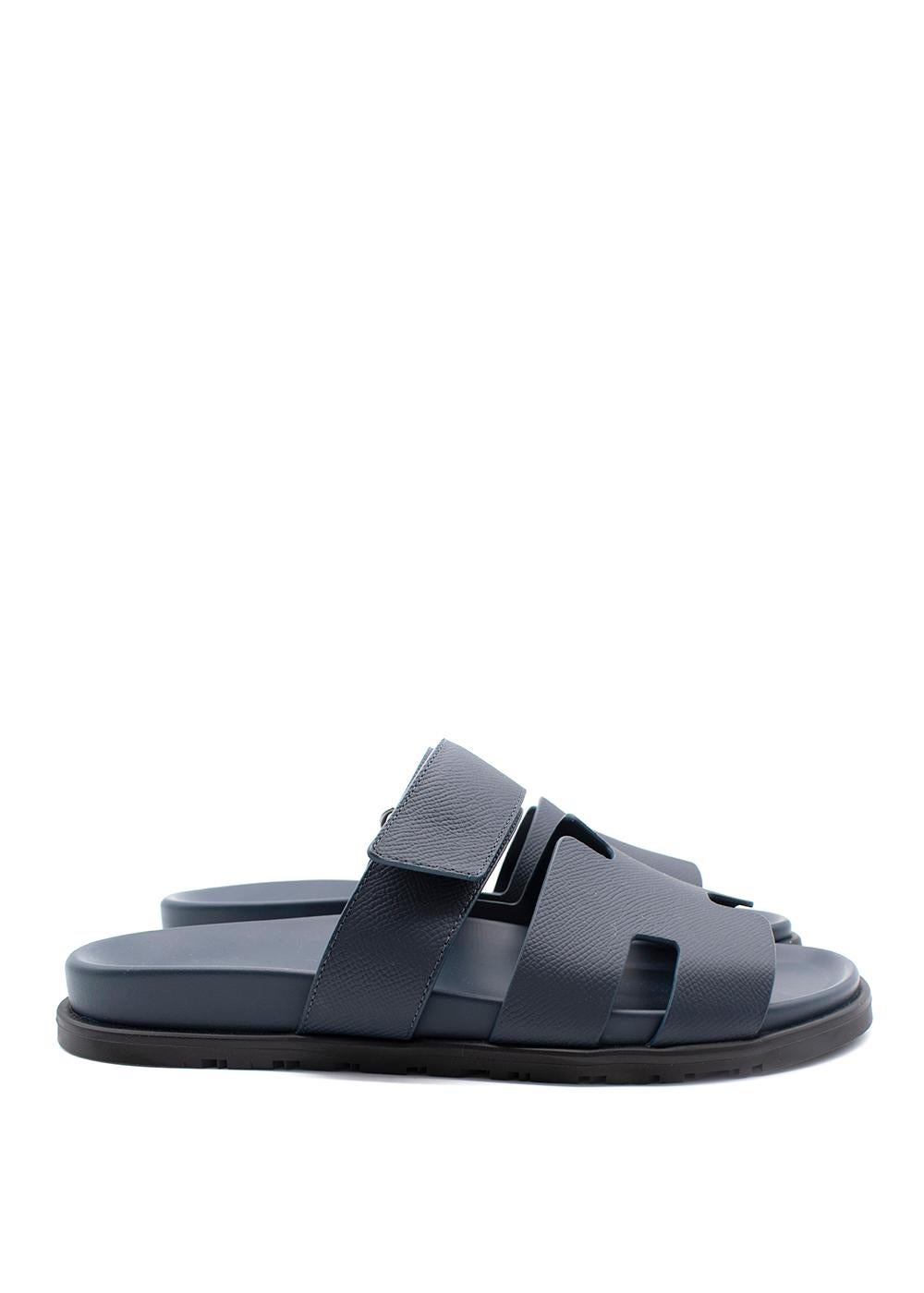 Hermes Blue Calfskin Chypre Sandals
- Iconic sandal with 'H' cut-out leather strap and adjustable velcro strap
- Deep leather-lined footbed
- Rubber sole with H embossed tread

Materials
Rubber
Leather

Made in Italy