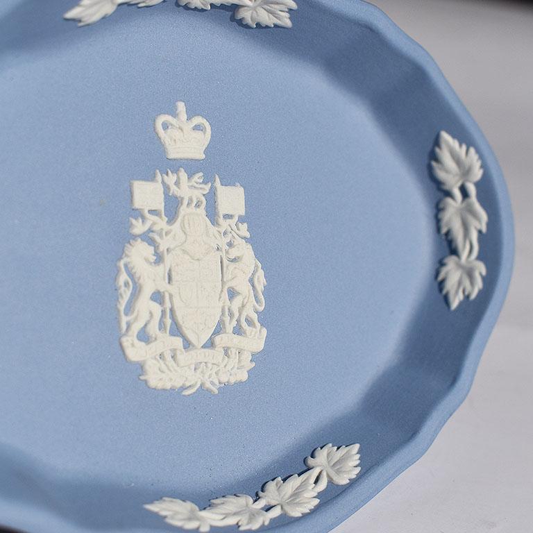 Jasperware dish in blue and white. This oblong dish with scalloped edges is blue with white floral decorations at the edges. At the center is the Canada coat of arms. Signed at bottom Special Edition Wedgwood, made in England.

Size: 4.32