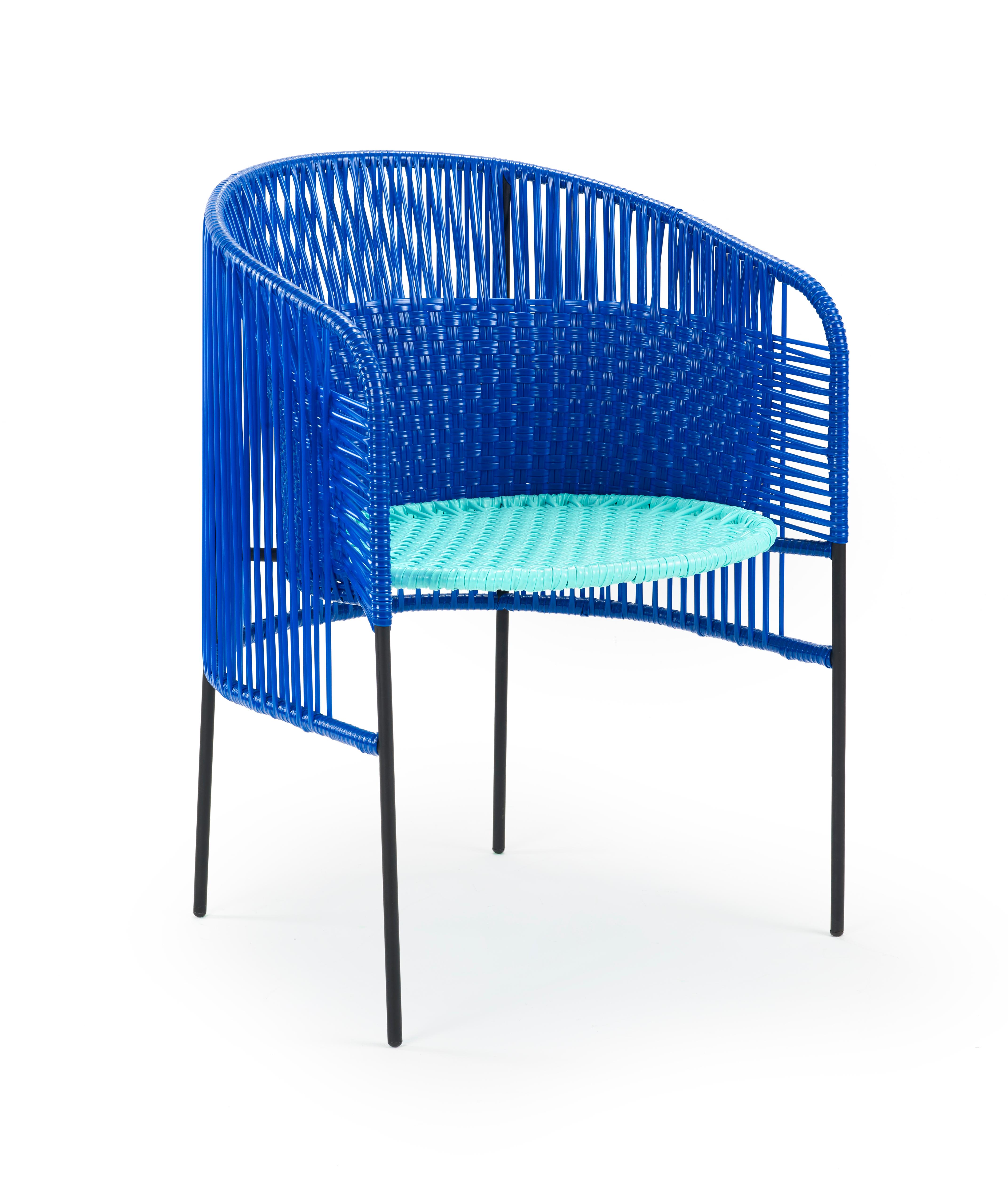 Blue caribe dining chair by Sebastian Herkner
Materials: Galvanized and powder-coated tubular steel. PVC strings are made from recycled plastic.
Technique: Made from recycled plastic and weaved by local craftspeople in Colombia. 
Dimensions: W