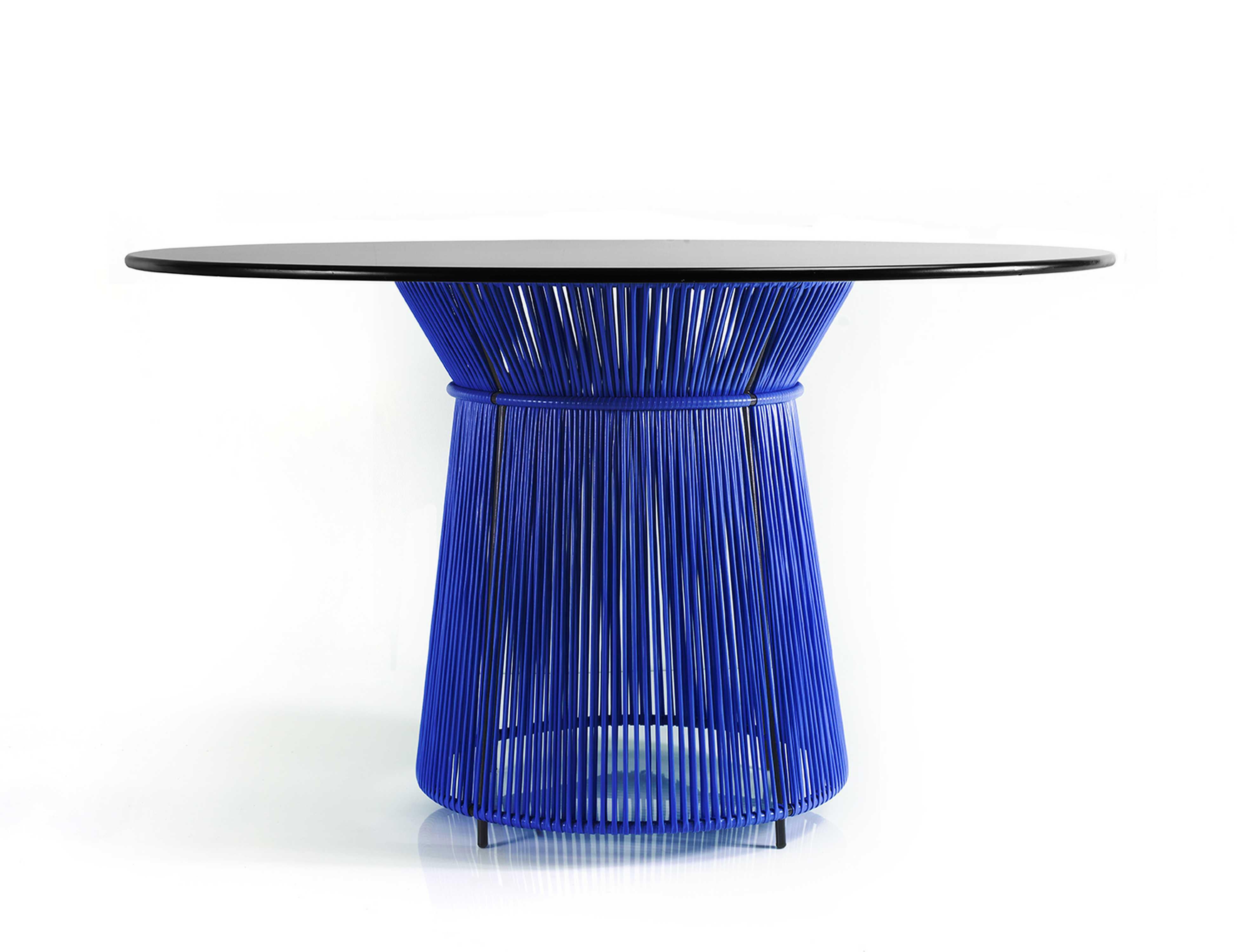 Blue Caribe dining table by Sebastian Herkner
Materials: Galvanized and powder-coated tubular steel. PVC strings are made from recycled plastic.
Technique: Made from recycled plastic and weaved by local craftspeople in Colombia. 
Dimensions: