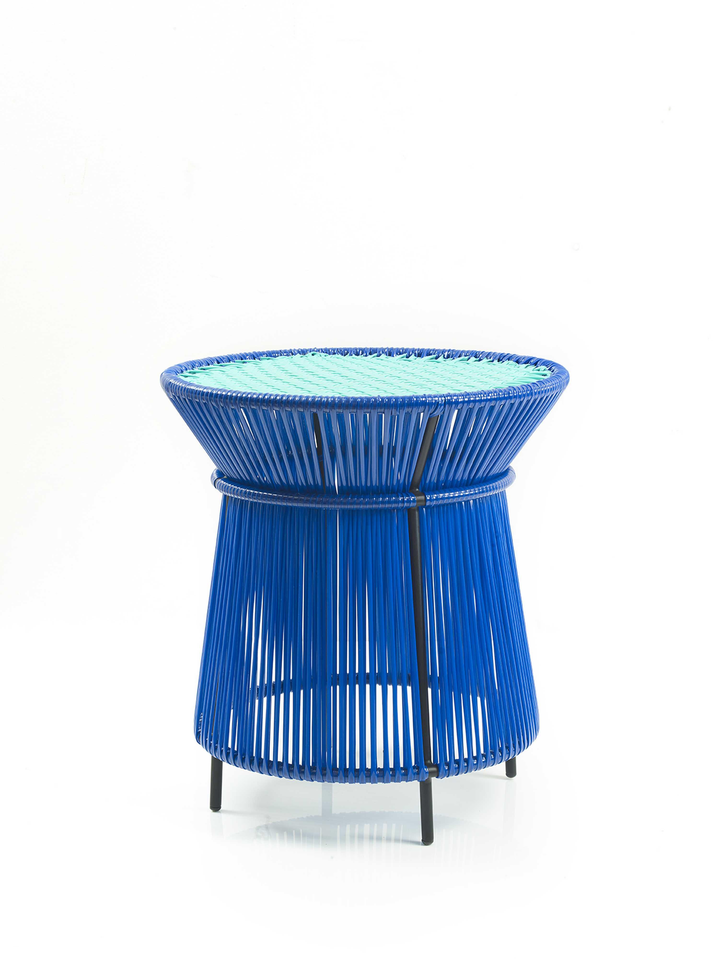 Blue Caribe High table by Sebastian Herkner
Materials: Galvanized and powder-coated tubular steel. PVC strings are made from recycled plastic.
Technique: Made from recycled plastic and weaved by local craftspeople in Colombia. 
Dimensions: