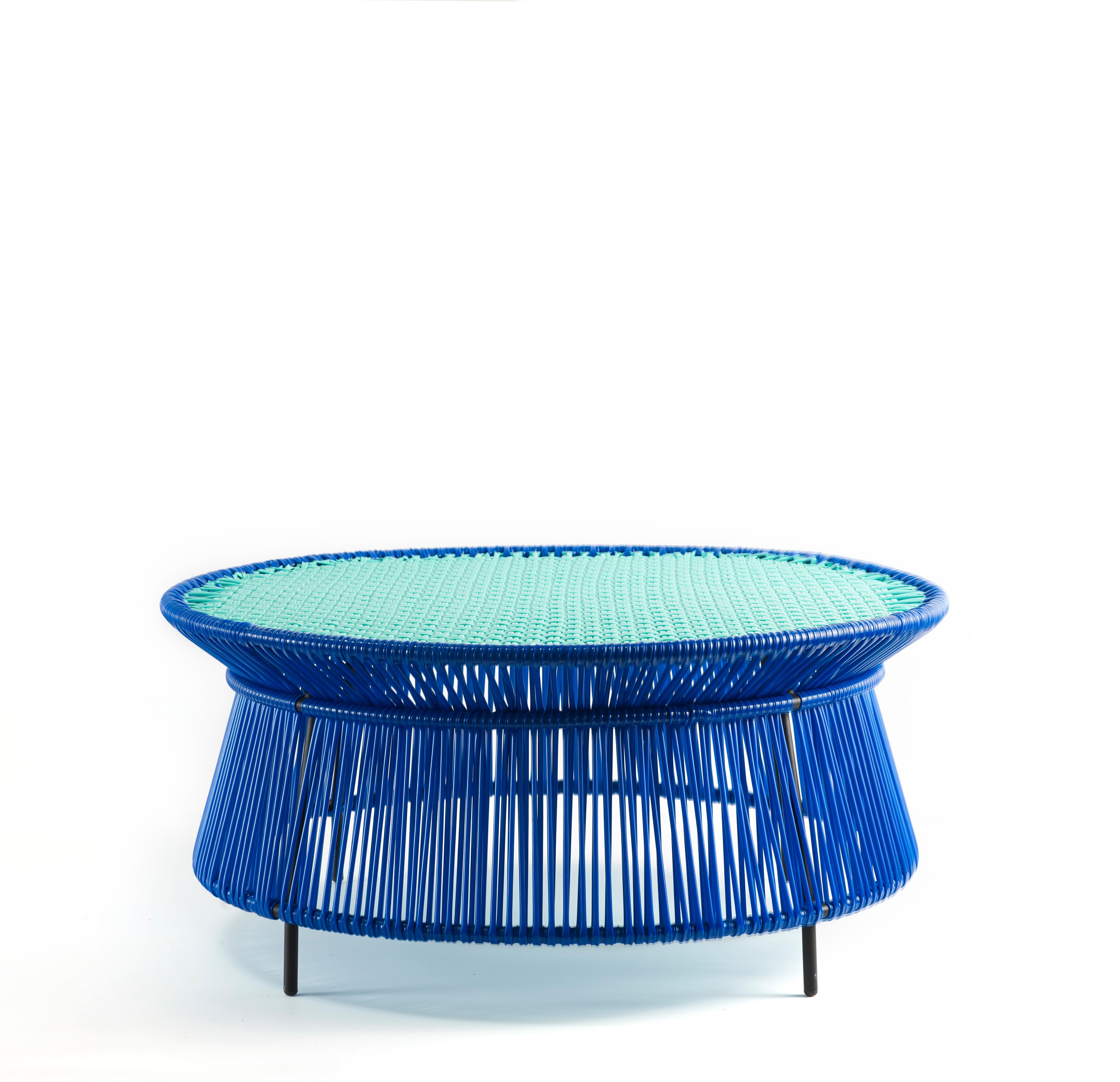 Blue Caribe low table by Sebastian Herkner
Materials: Galvanized and powder-coated tubular steel. PVC strings are made from recycled plastic.
Technique: Made from recycled plastic and weaved by local craftspeople in Colombia. 
Dimensions: