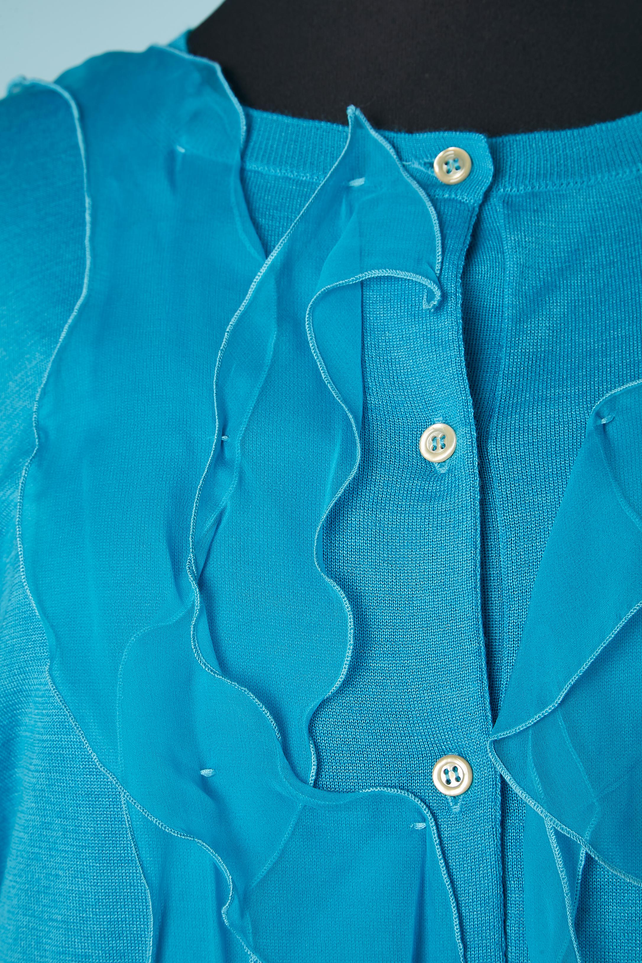 Ensemble cardigan en cachemire bleu et robe en mousseline de soie bleue. Composition du cardigan : 70% cachemire, 30% soie. 
Robe : 100% mousseline de soie. Application de rubans de mousseline de soie en coupe brute sur la robe. 
TAILLE cardigan :