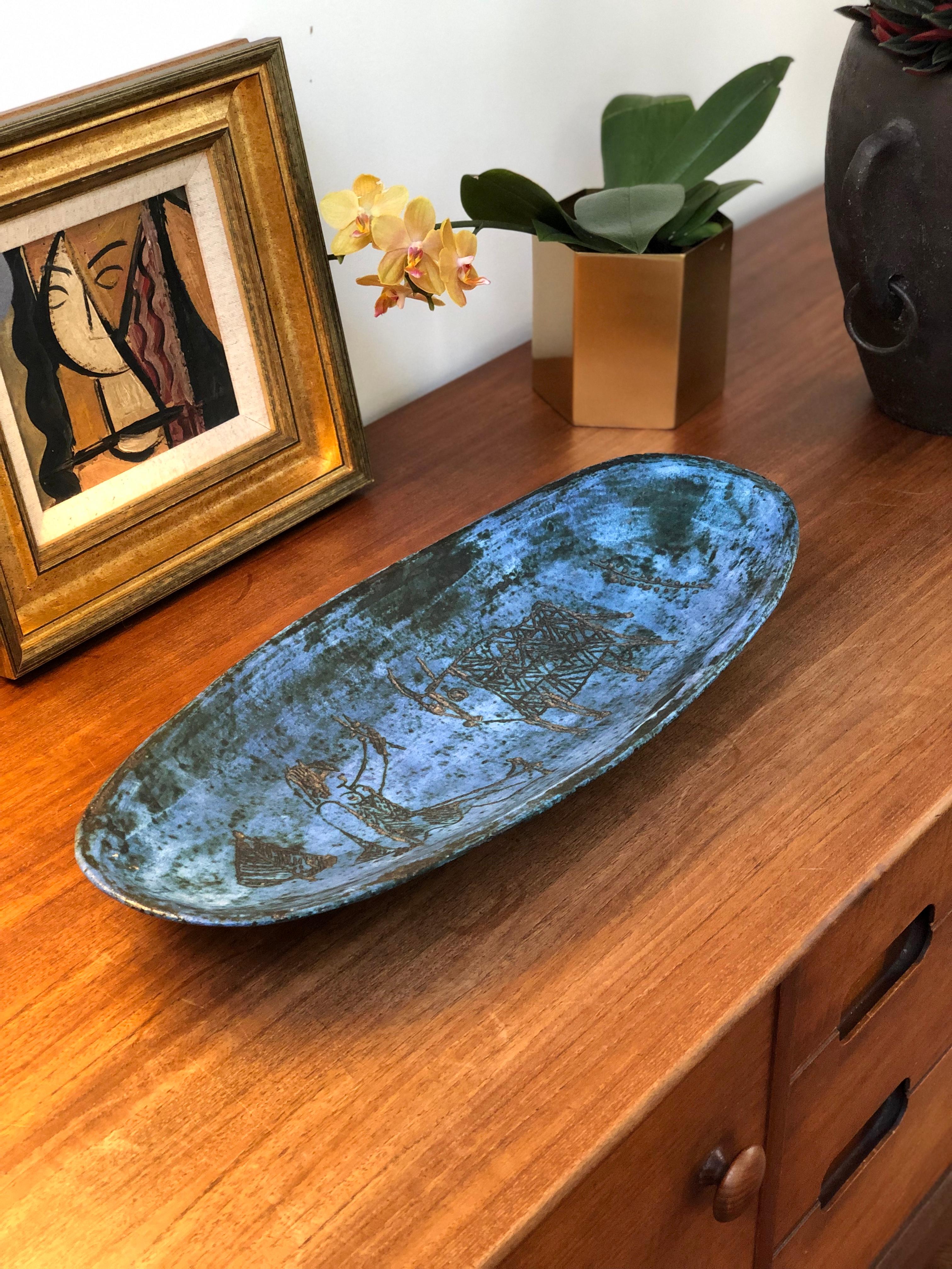 This wonderfully elegant ceramic tray (circa 1950s) has Blin's trademark cloudy blue glaze featuring primeval images of a tree, a seated woman with outstretched arm, a bull and a plant etched in the center of the piece but seemingly from an