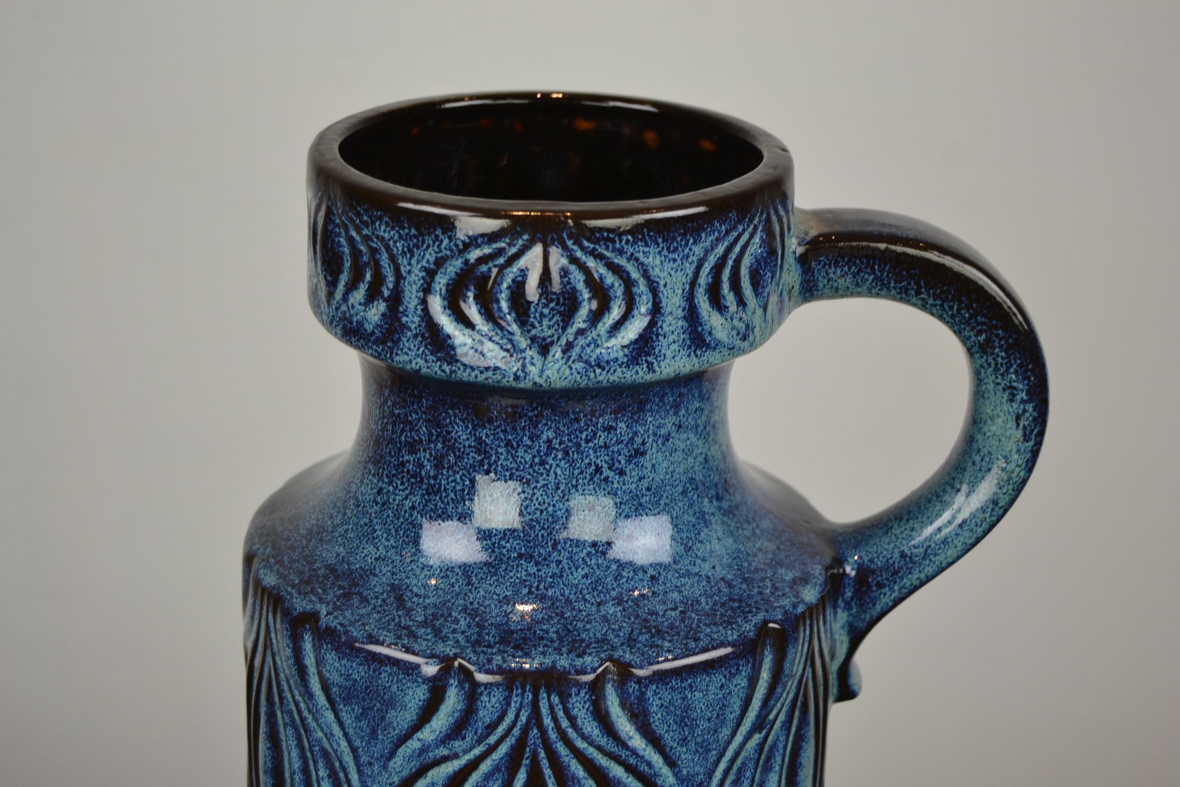 Blue floor vase with handle by Scheurich, Western Germany.
This 1960s blue ceramic vase is marked under 485-45, Western Germany. 

This vase has a beautiful blue color and minimalistic design on the vase.
It fits also our blue chair very well