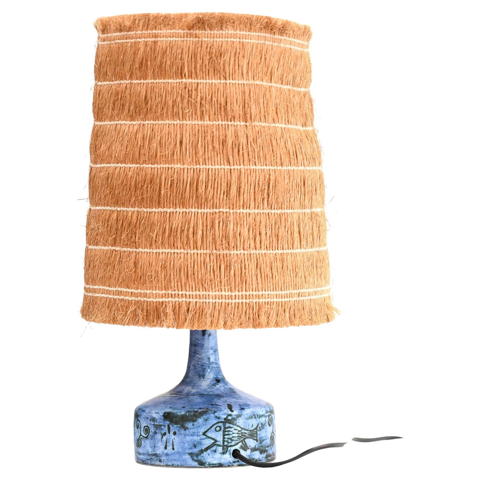 Jacques Blin table lamp “Whisky” model with its original lampshade

Mid-century ceramic table lamp (circa 1950s) by Jacques Blin, in iconic Jacques Blin blue with sgraffito-etched fish and geometric motifs in very good vintage condition