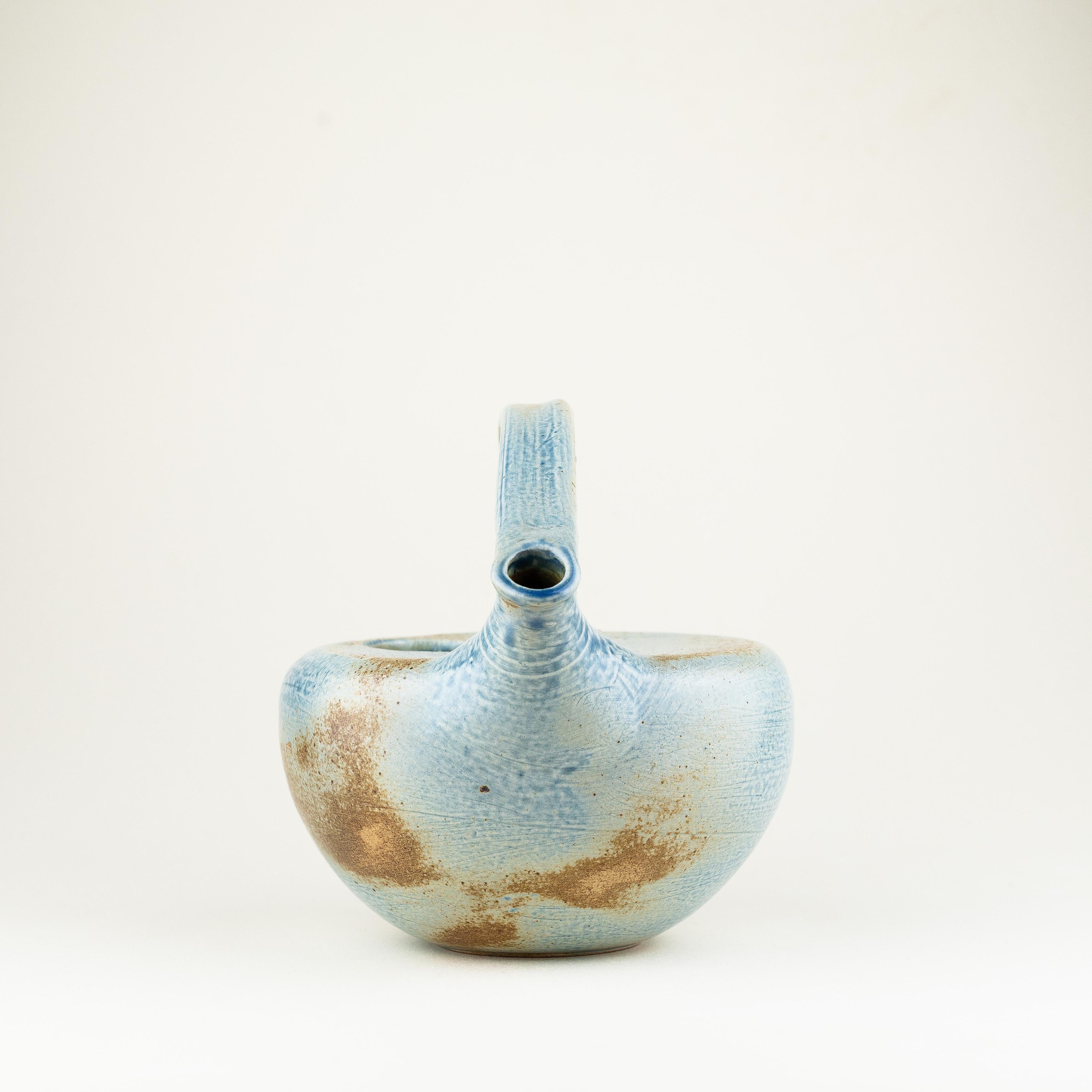 Blue Ceramic Tea Pot, Mid-Century Modern, from France.

Very elegant teapot from the 1960s in ceramic with blue and brown glaze. 

A sleek and stylish design. 

Anonymous French artisanal work. 

Very good condition and nice patina !
 