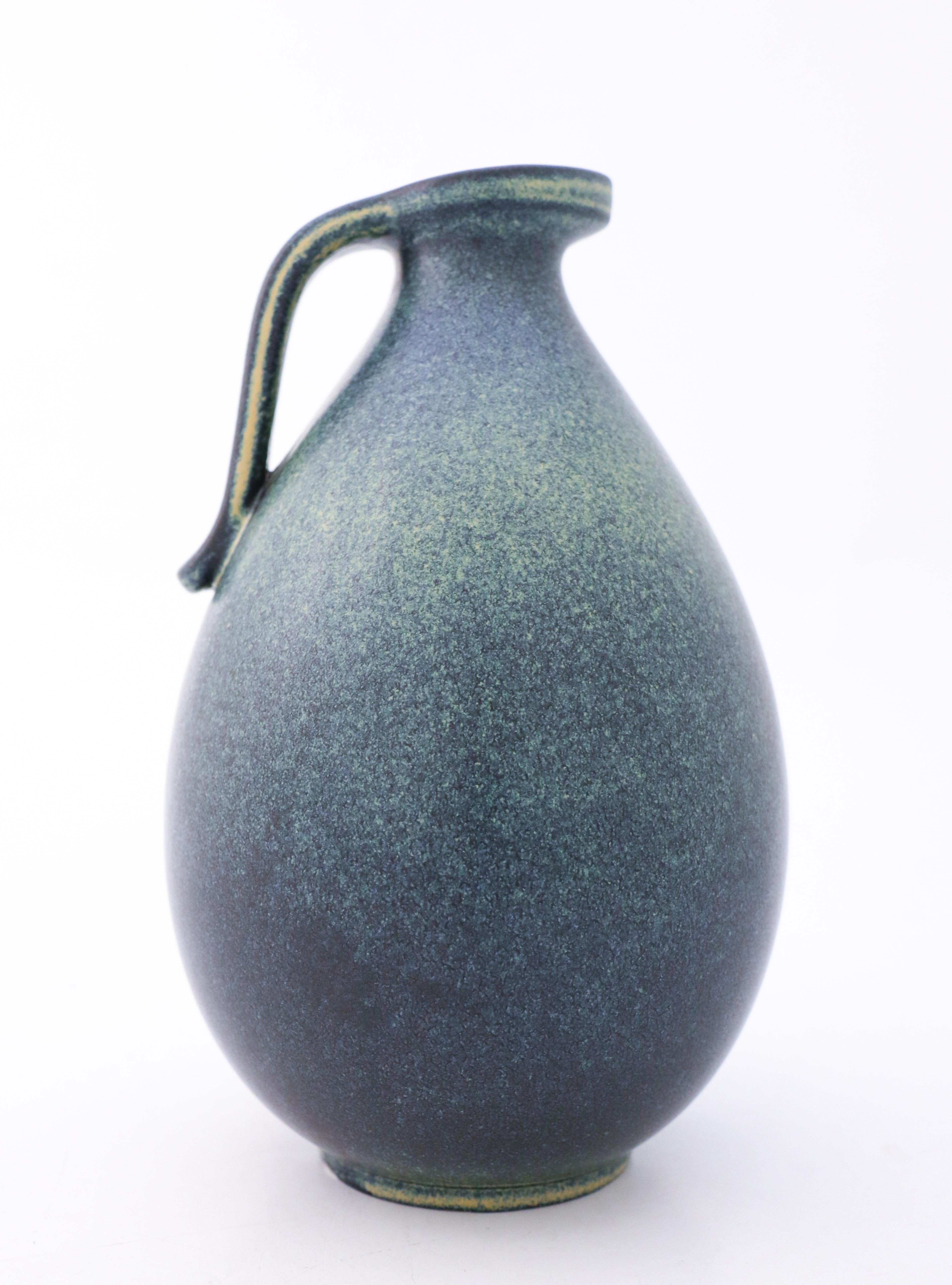 A blue vase with a lovely glaze designed by Gunnar Nylund at Rörstrand, it´s 24,5 cm (9.8) high. It´s in excellent condition except from some minor marks in the glaze and marked as 1st quality. 

Gunnar Nylund was born in Paris 1904 with parents