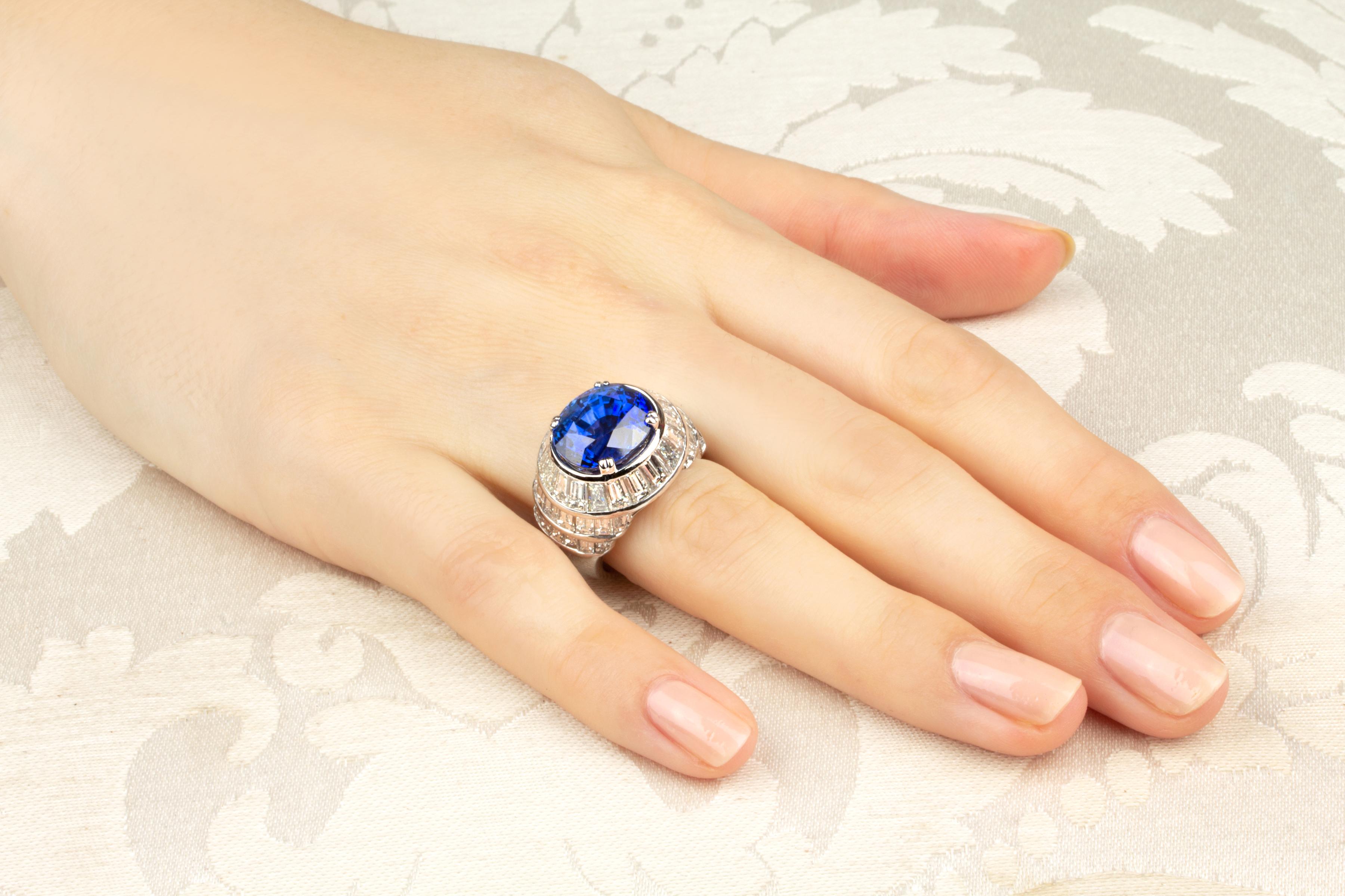 The blue Ceylon sapphire and diamond ring features a magnificent oval faceted 11.23 carat blue Ceylon sapphire of intense and crystalline “Madonna blue” color.  The stone is set in a sophisticated, harmonious design all composed of custom cut