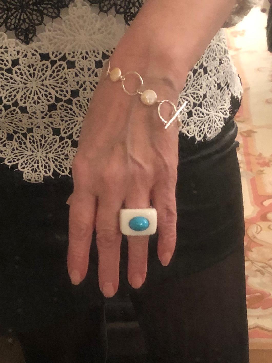 Blue Chalcedony Art Deco Ring with Turquoise Stone set in Sterling Silver.
Chalcedony is a member of the Quartz family. Its name may be derived from the Greek port city of Chalcedon. The ancient civilizations of Egypt, Greece and Rome used varieties