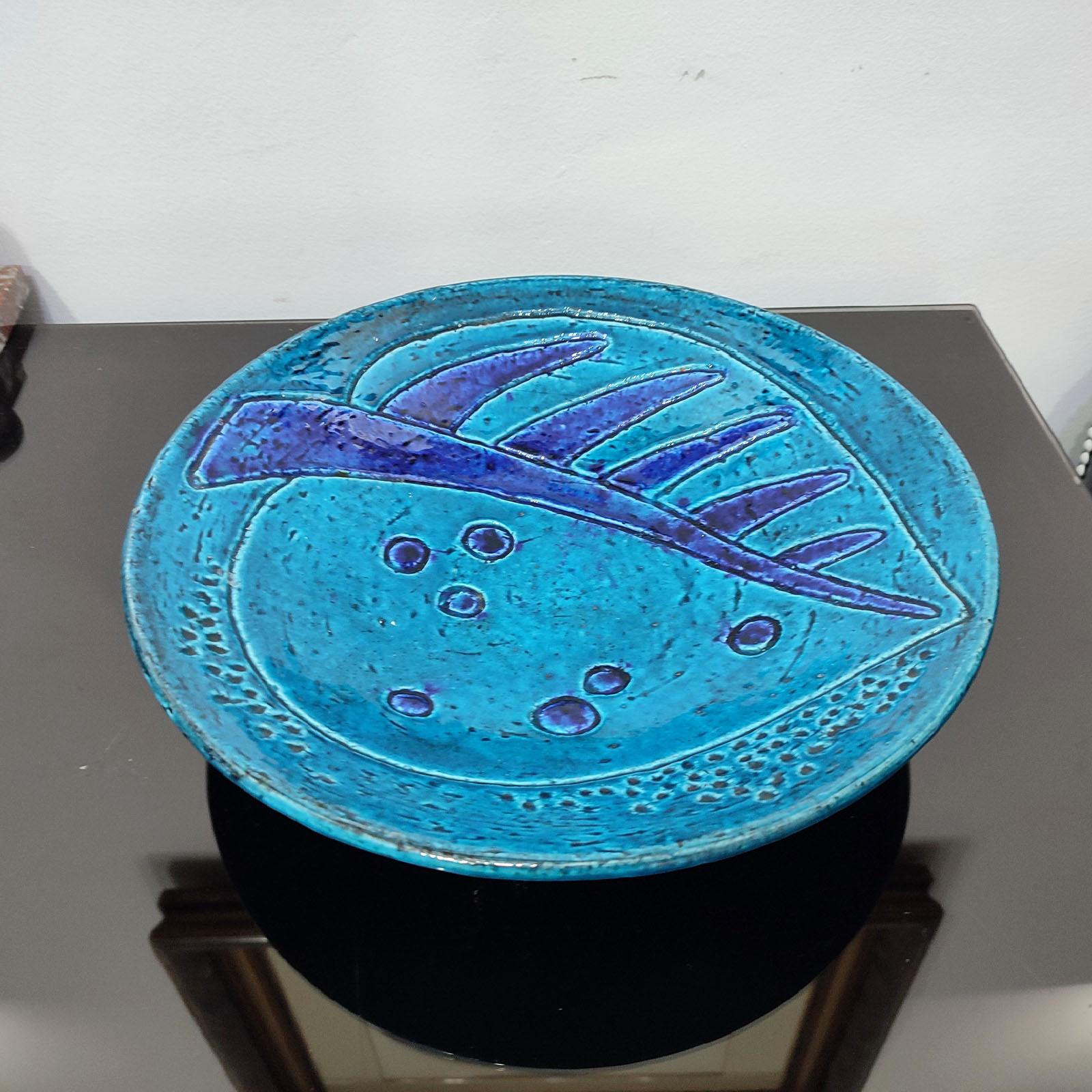 A large chamotte stoneware bowl (plate) by Swedish designer Charlotte Hamilton (1883-1980) produced by Rörstrand 1946-49. 
Decorated with a large leaf, in contrast tones of light and dark blue.
Excellent vintage condition with minor signs of
